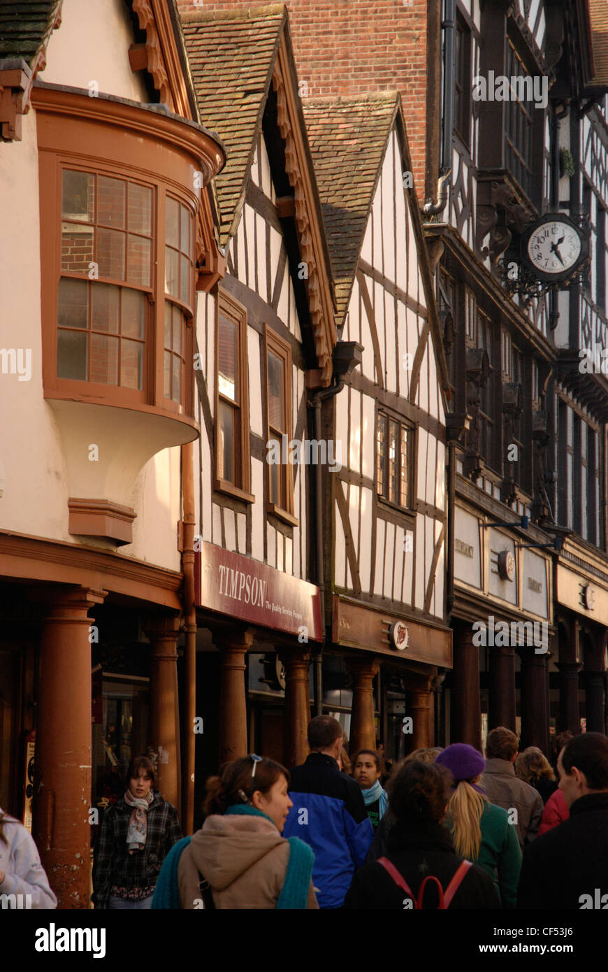 View of High Street showing shoppers and Tudor buildings in Winchester