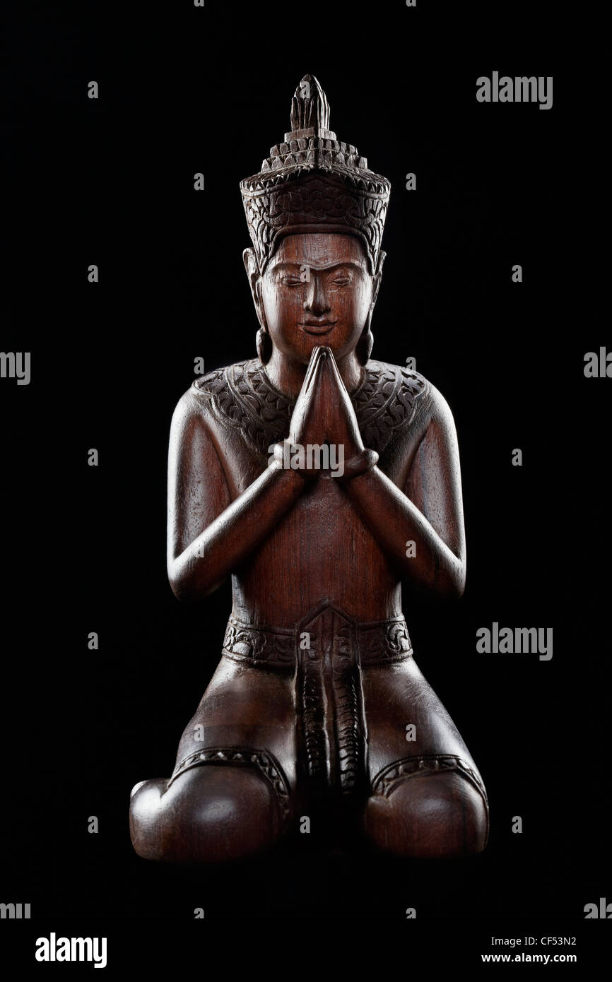 A peaceful and calming statue of an Orant (assistant of Buddha) Stock Photo