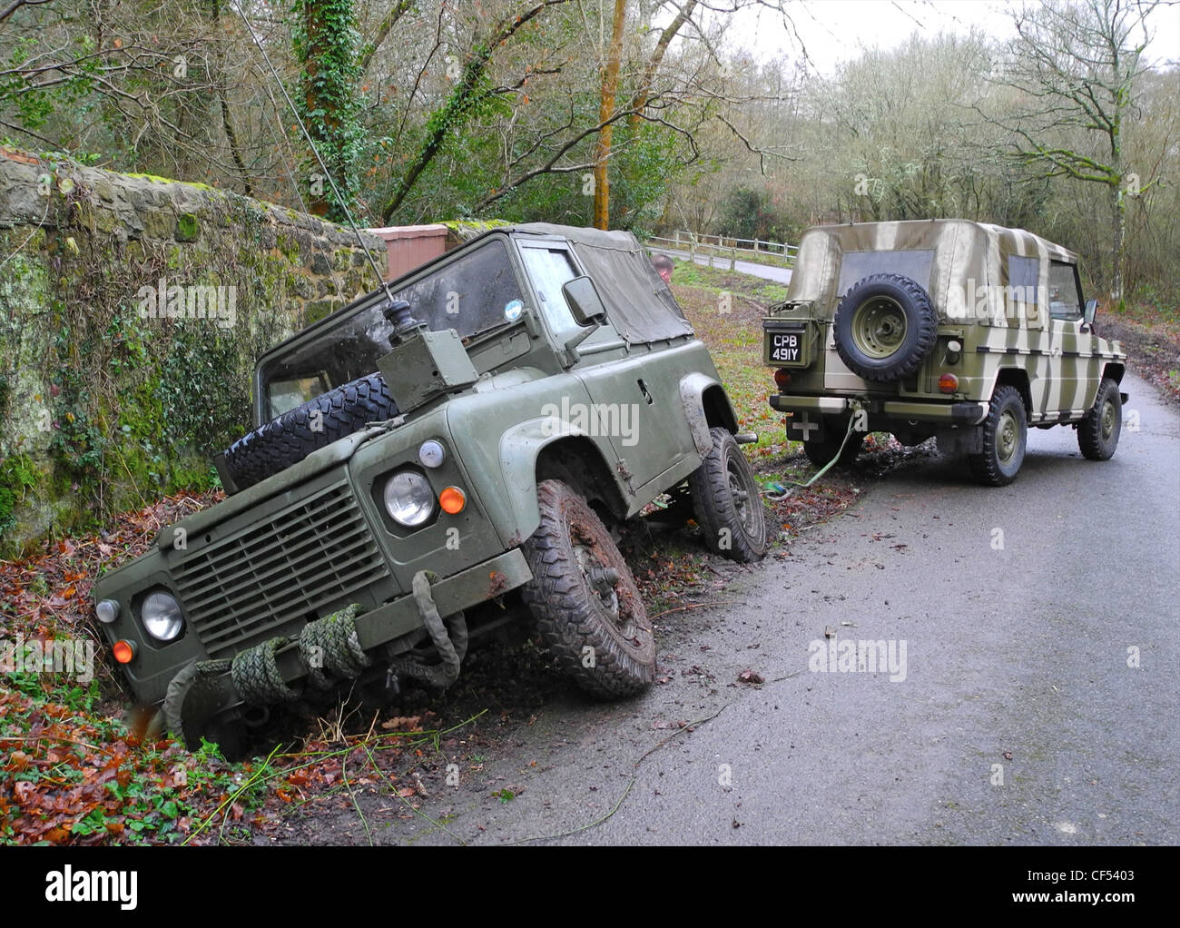 A former military Landrover in a ditch. This is a short wheelbase Defender. Stock Photo