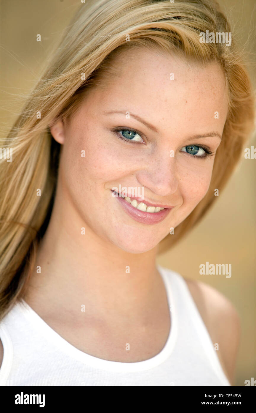 Female With Long Straight Blonde Hair And Blue Eyes Wearing A