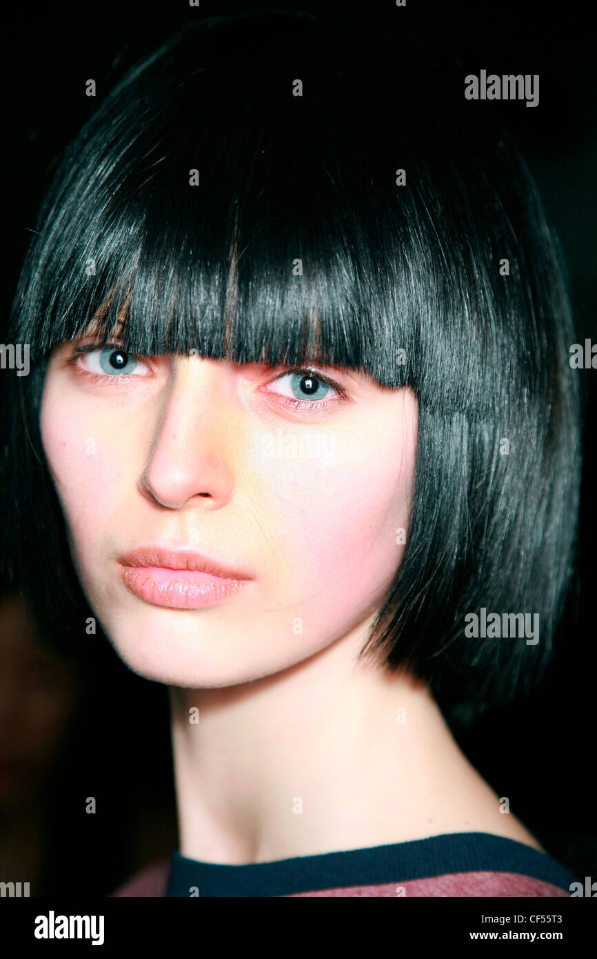 Marc Jacobs Backstage New York Autumn Winter Model, black hair in short bob with fringe, wearing gold shimmery lipgloss Stock Photo