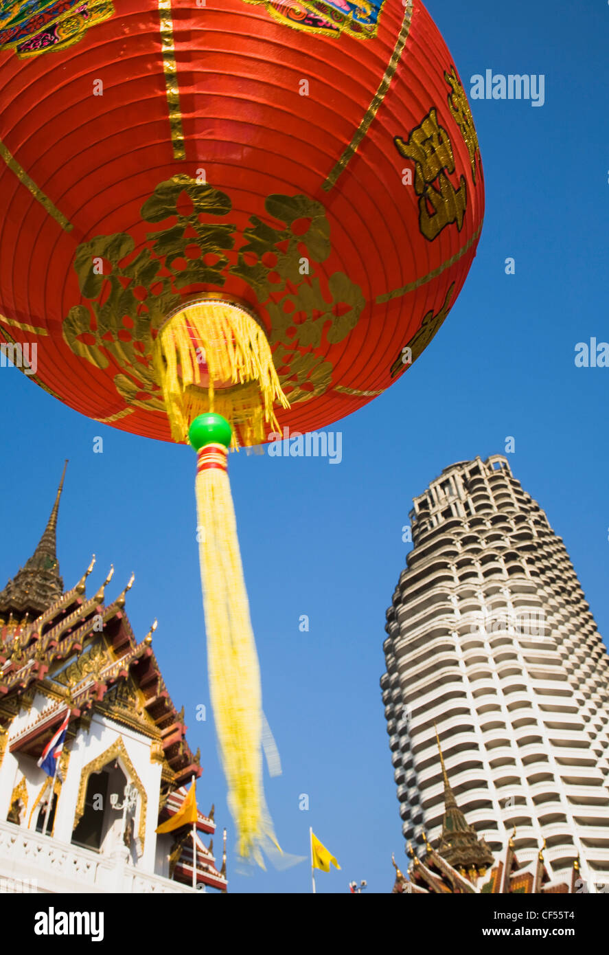 Thailand, Bangkok, Wat Yannawa temple roof and unfinished apartment block from 1990's Asian financial crash Stock Photo