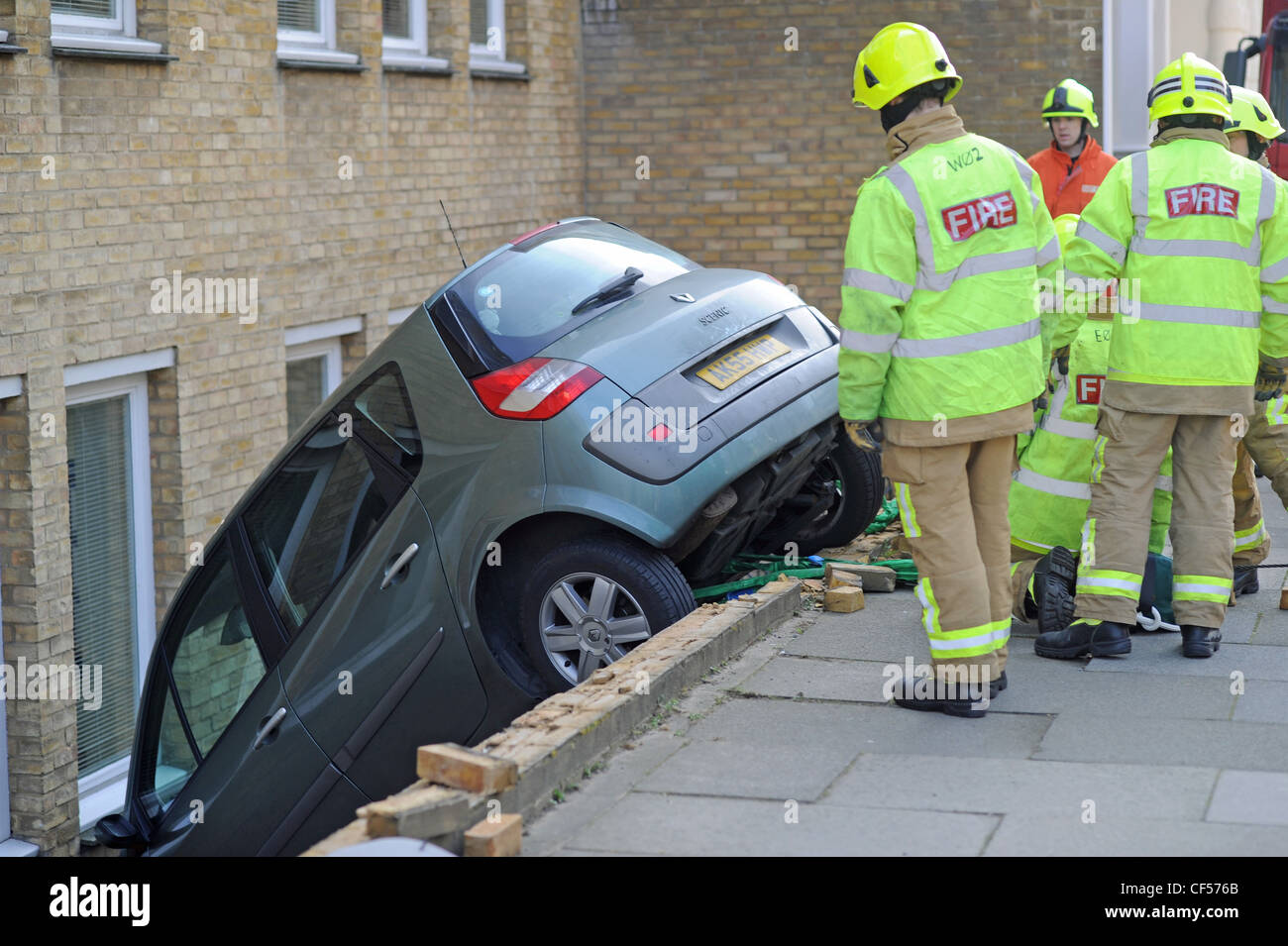 Emergency services attend to a Renault car which had crashed through