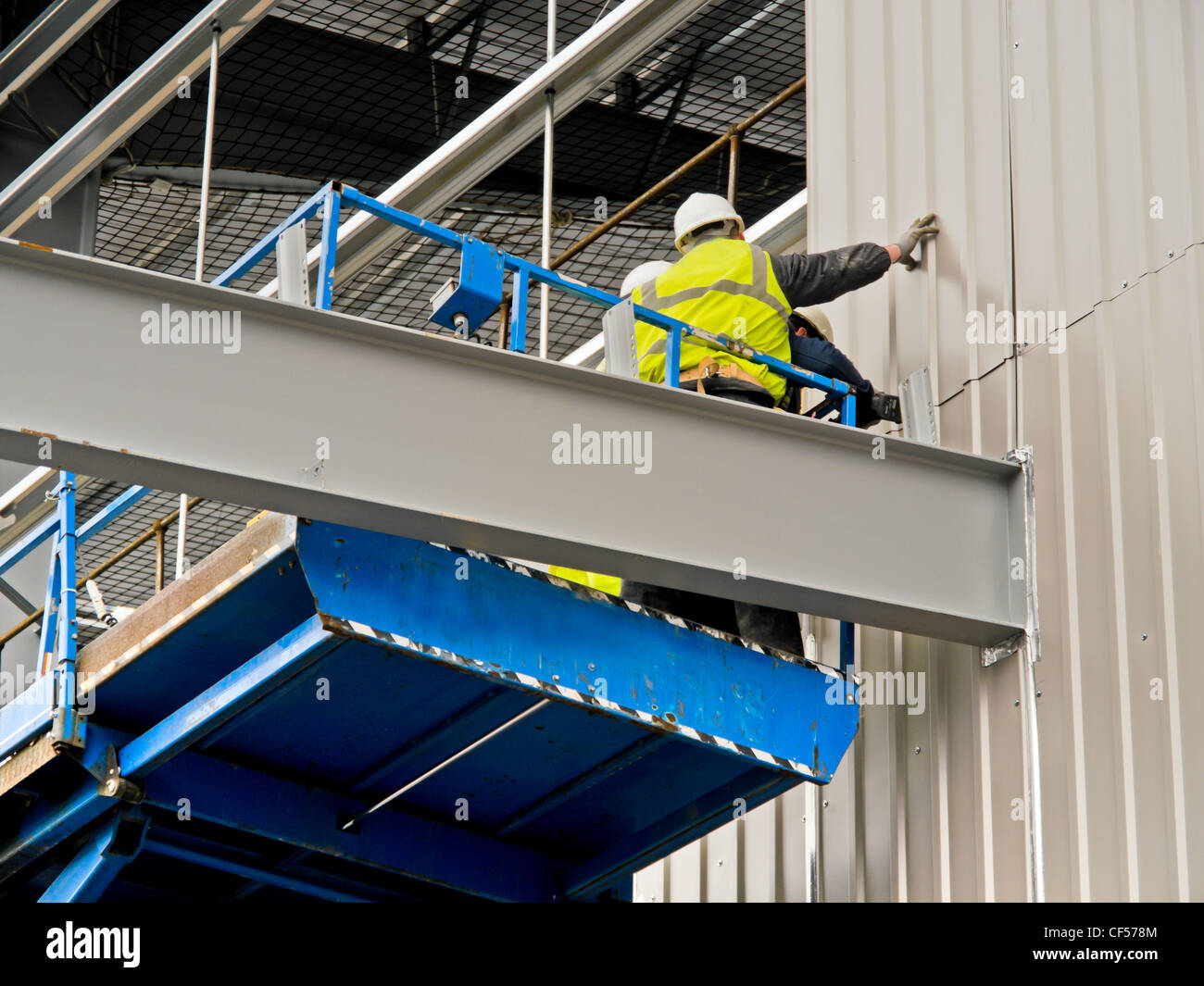 Adding cladding to a building under construction, Stock Photo