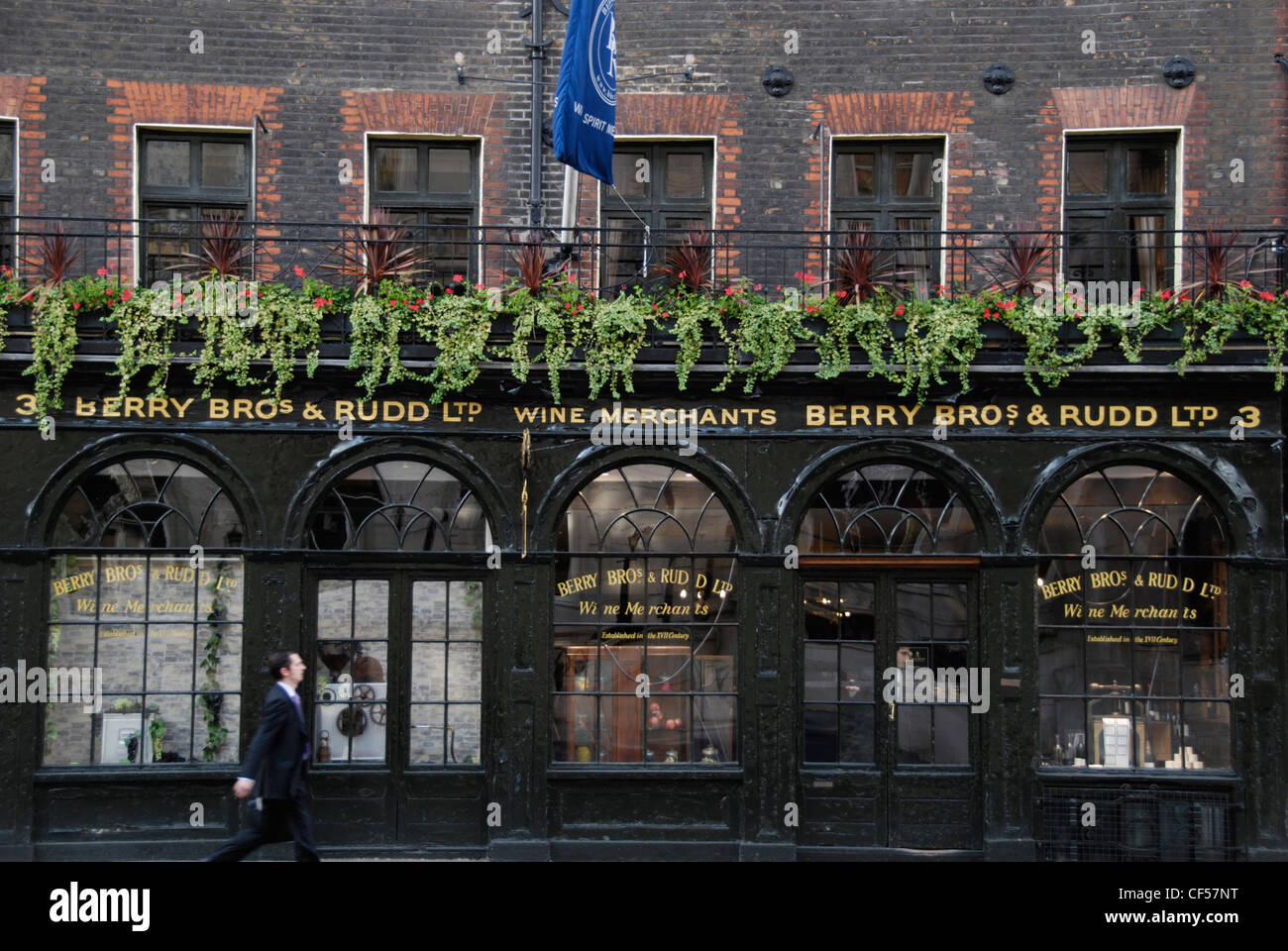 A businessman passing the Berry Bros and Rudd fine wine merchants on St James Street. Stock Photo