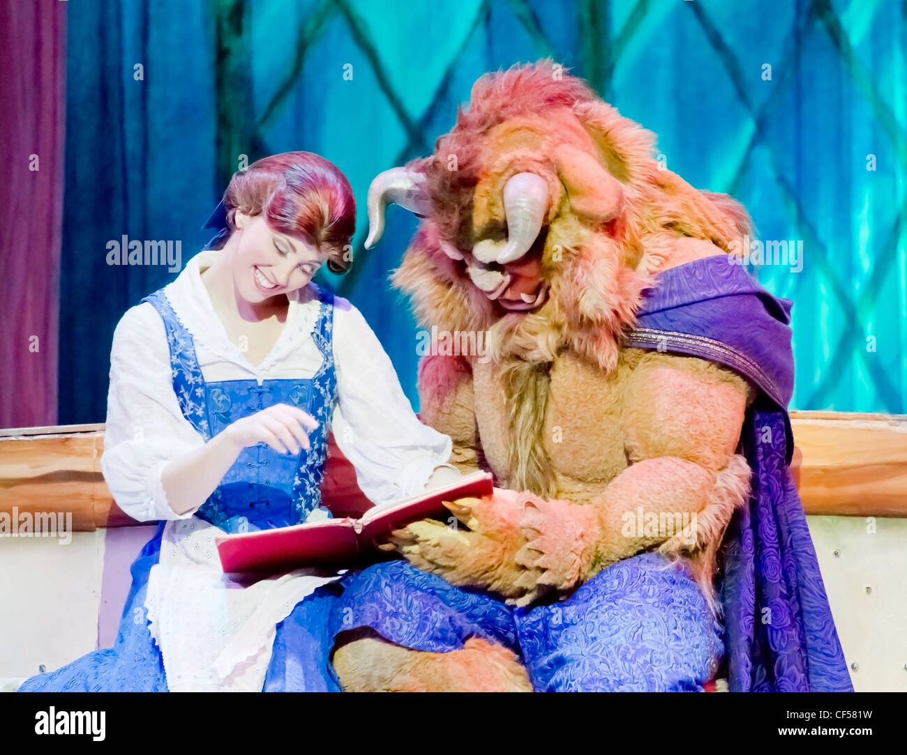 Belle and Beast from Beauty and the Beast read a book at the Disney Princesses show at the Resch Center in Green Bay Stock Photo