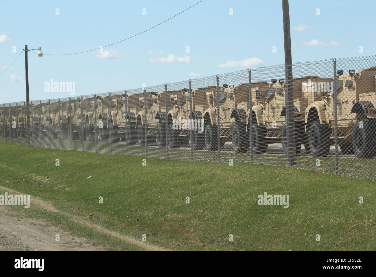 Oshkosh Truck Corp Military Humvees are all lined up at the airport ready to be shipped overseas for the war on April 3, 2012 Stock Photo