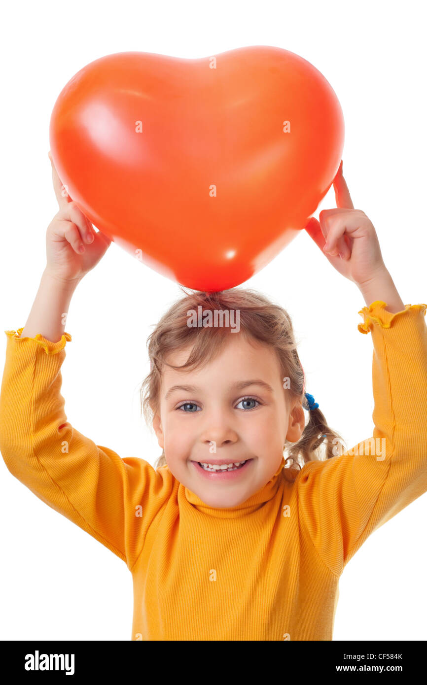 laughing little girl holds over her head heart shape balloon isolated