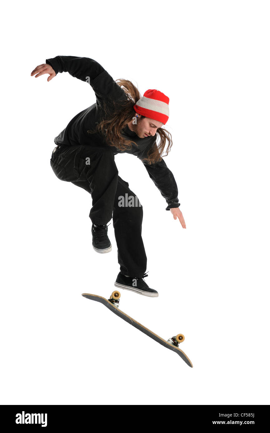 Skateboarder doing a trick isolated on a white background Stock Photo