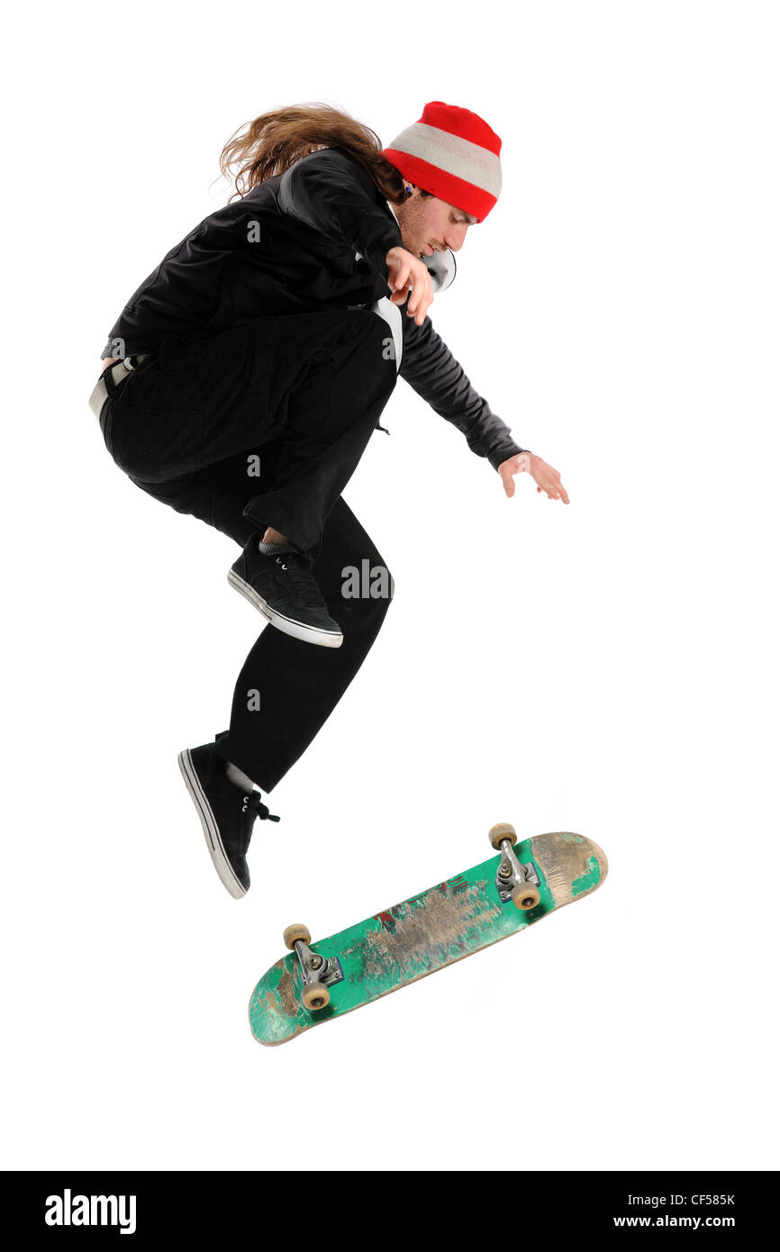 Skateboarder doing a trick isolated on a white background Stock Photo