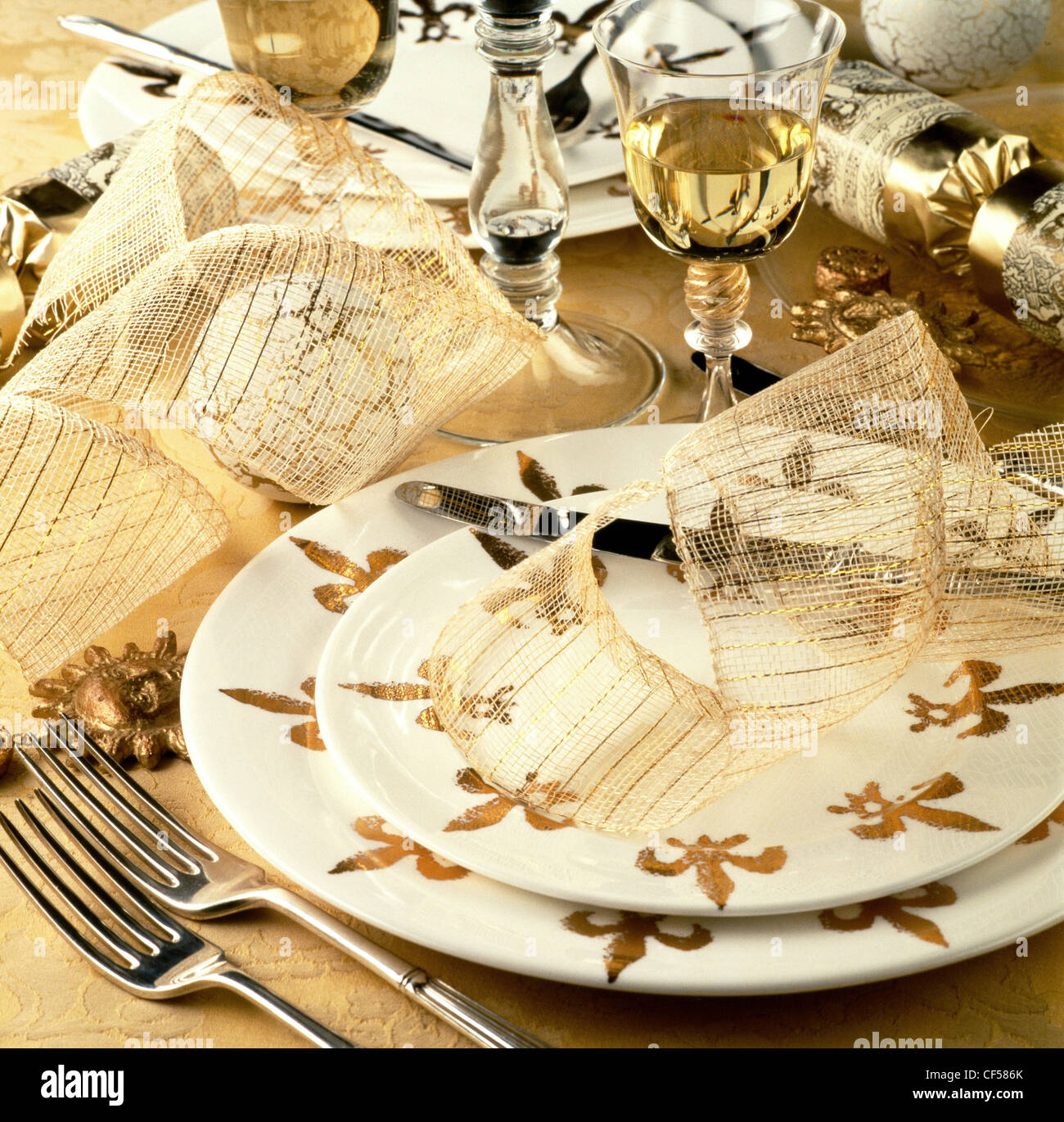 A special gourmet feast Table setting with white and gold fleur de ... A special gourmet feast Table setting with white and gold fleur de ...