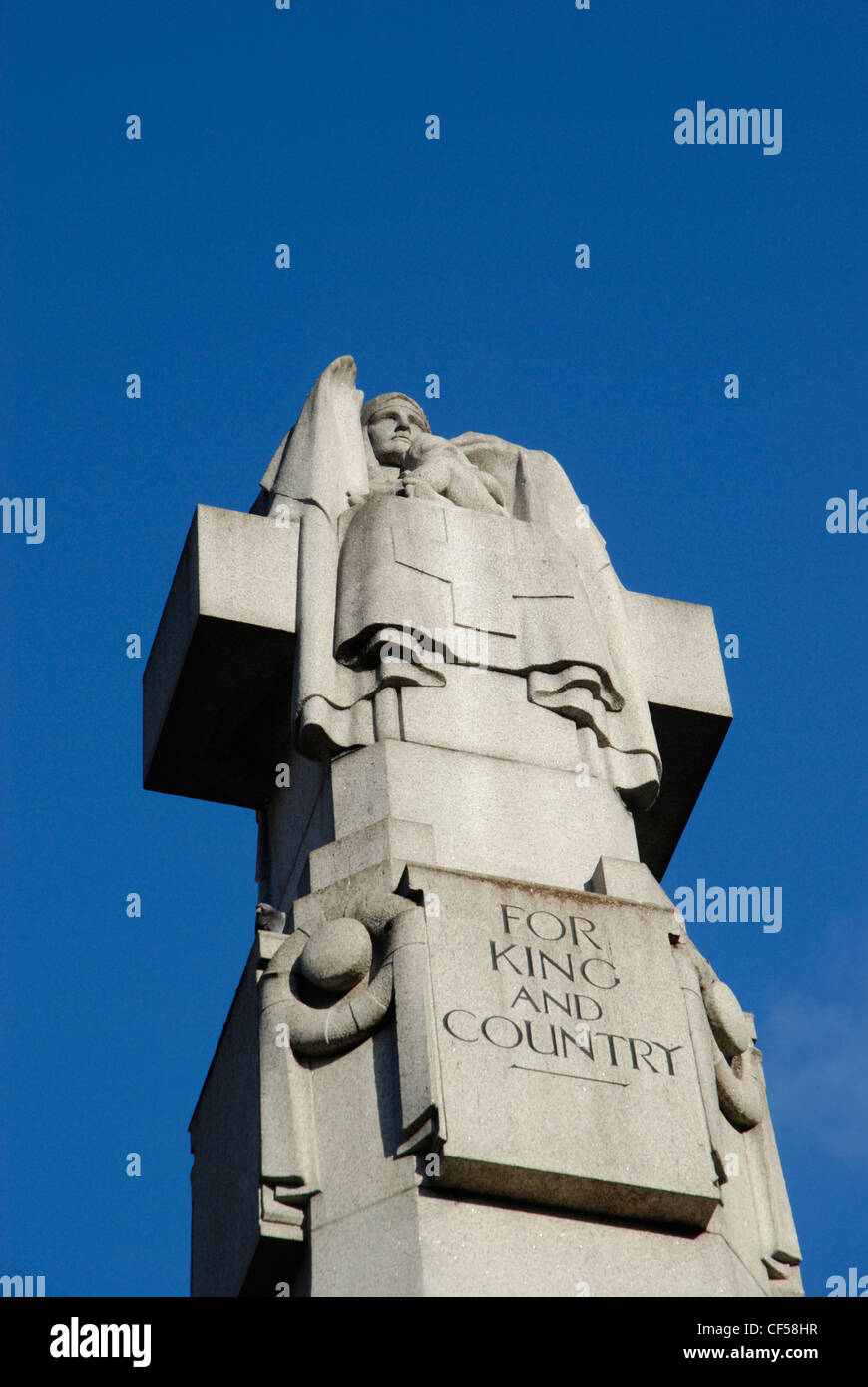 Stone war memorial showing the statue of a nurse and the words For King and Country. Stock Photo