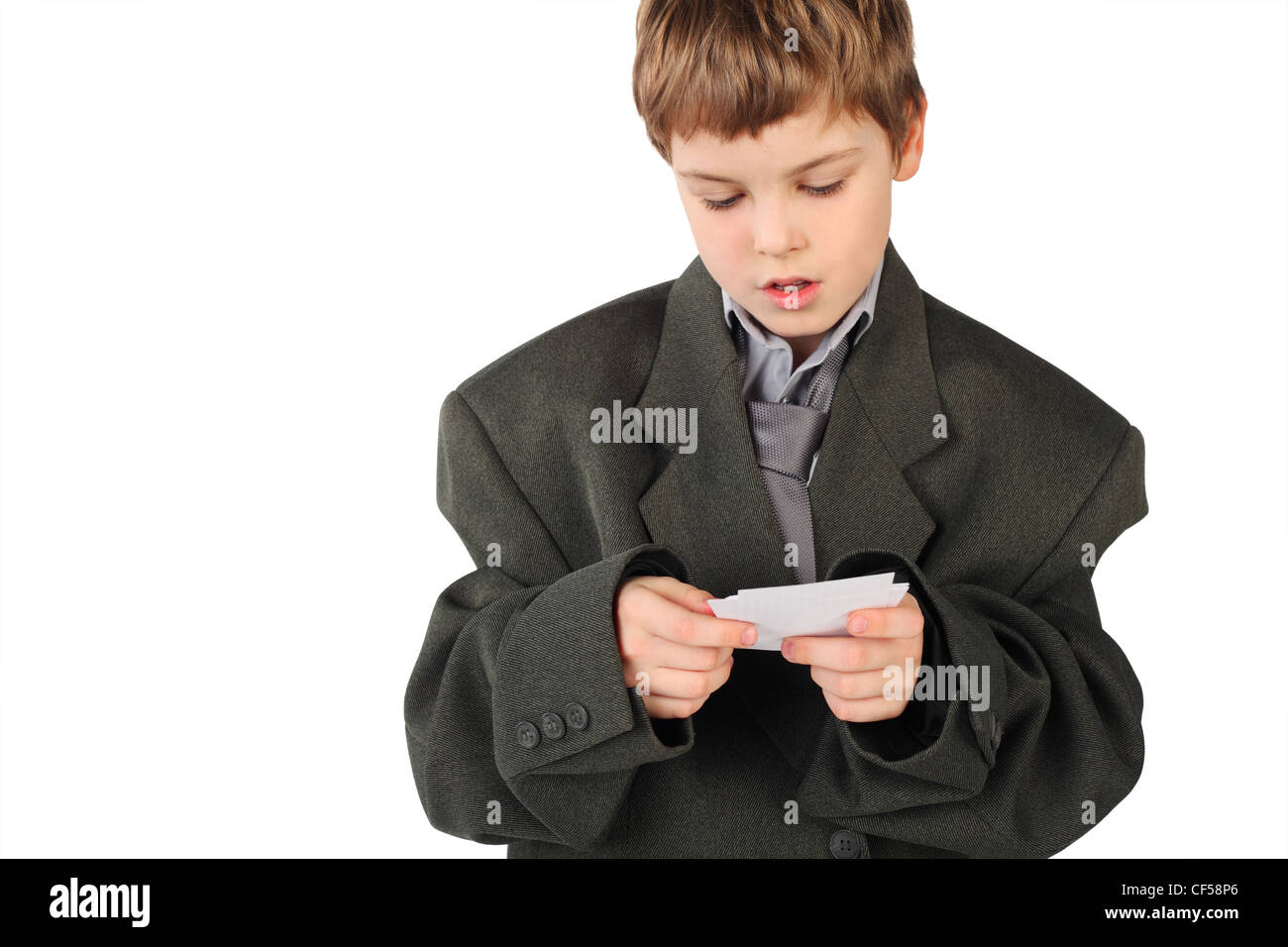 little boy in big grey man's suit looking at business card isolated on