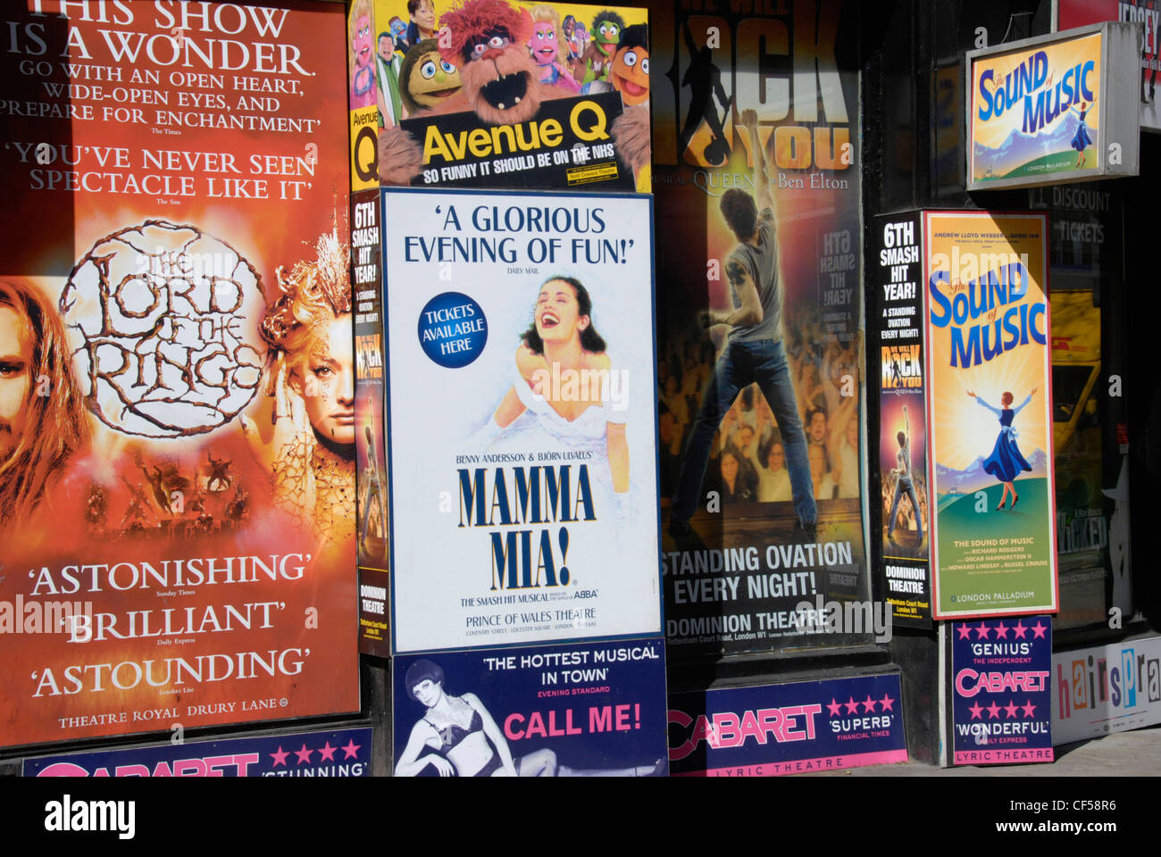 Posters advertising numerous plays and musicals outside London West End ticket agent. Stock Photo