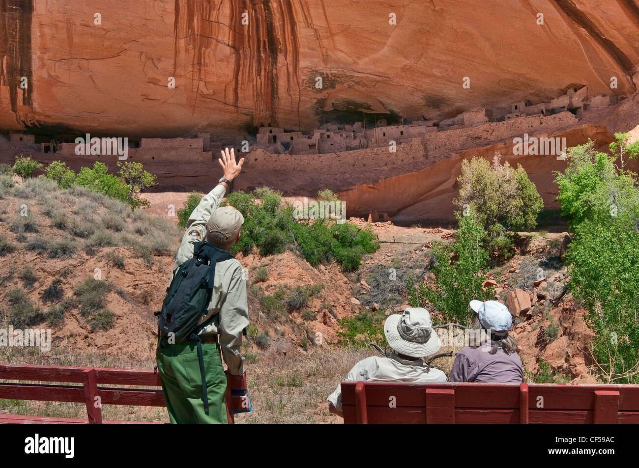 Park volunteer ranger and visitors at Keet Seel ruins at Navajo