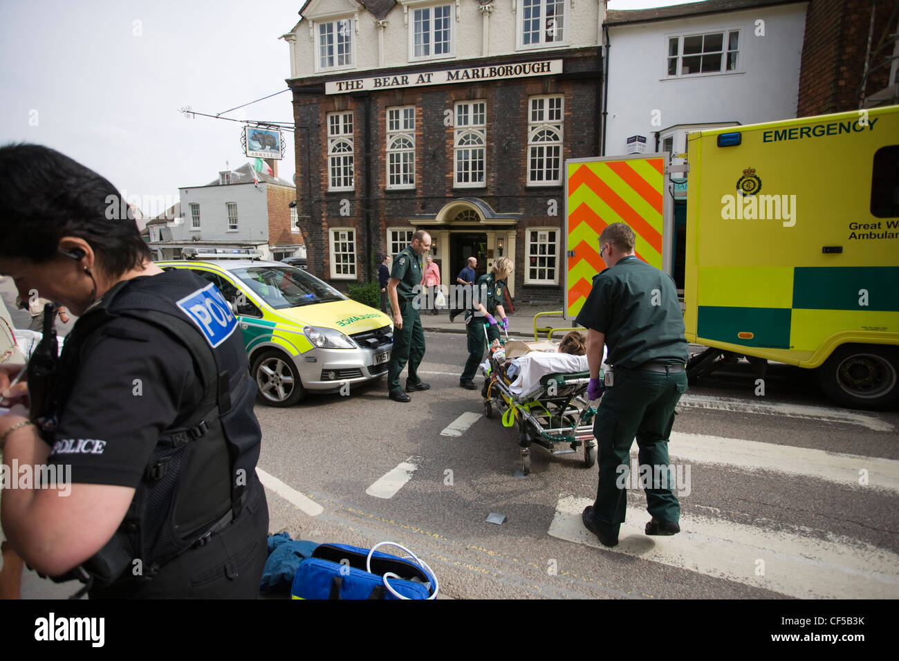 Amulances and paramedics at the scene of an accident, a woman hit on a zebra crossing, police take statements from witnesses Stock Photo