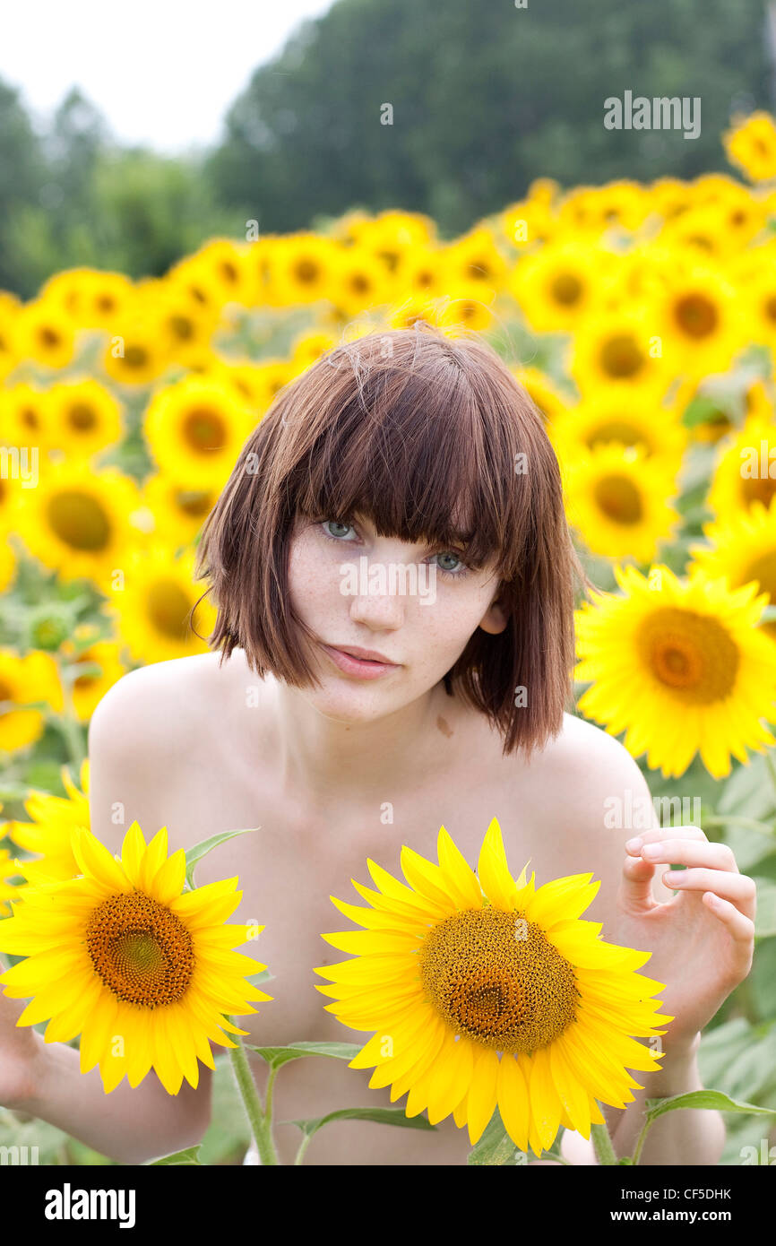 nudist sunflowers Female with short fringed brunette hair, standing nude in the sunflower  field, unsmiling, looking at camera Stock Photo - Alamy