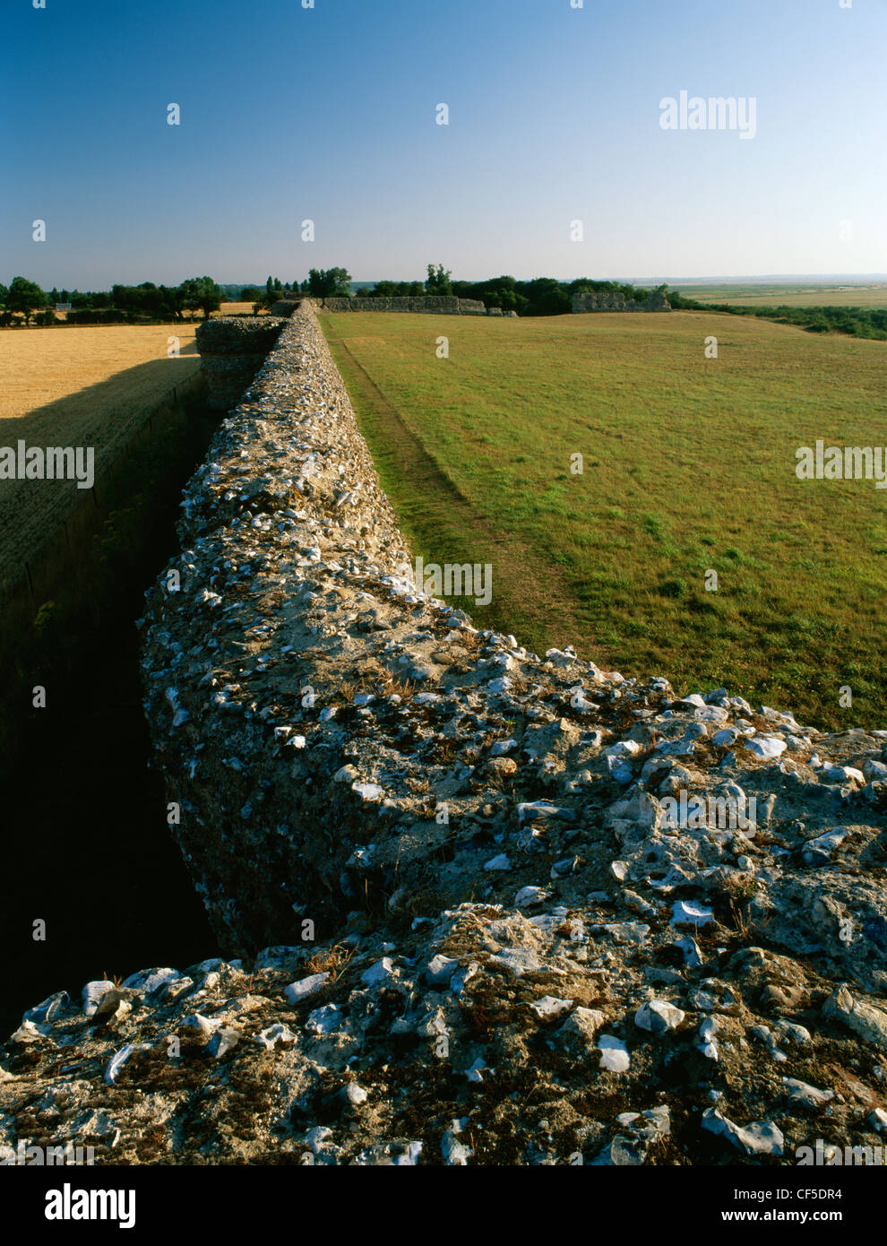 Looking from the NE corner tower along the southern wall and projecting bastions of Burgh Castle Roman Fort, a rectangular fort Stock Photo