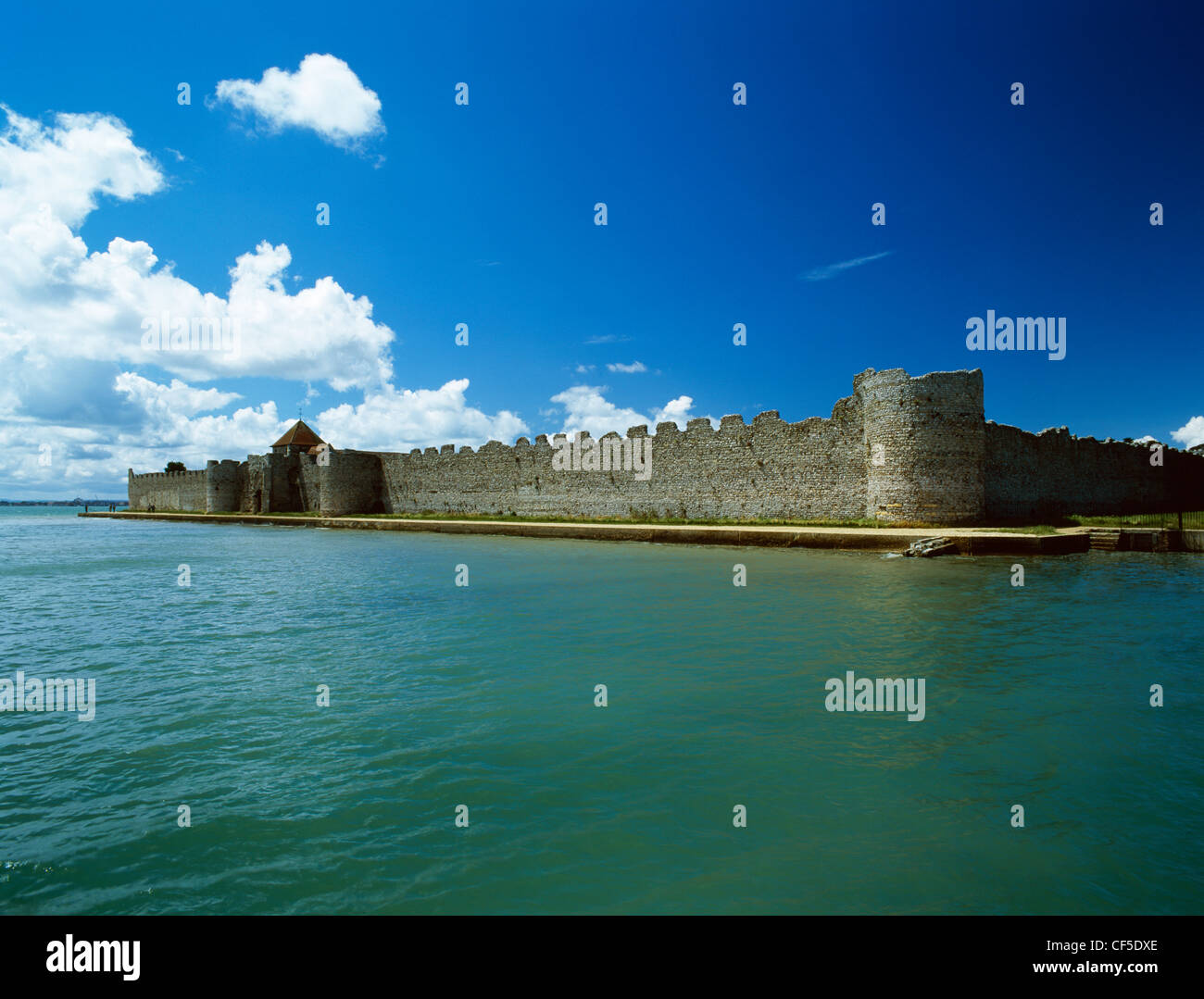A view from Portsmouth Harbour of the E wall of the 3rd-century AD Portchester Castle Roman Fort built by the Romans against Sax Stock Photo