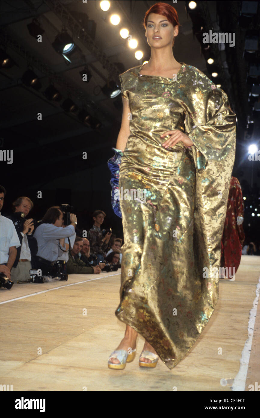 Commes de Garcons Spring Summer Canadian model Linda Evangelista wearing draped gold dress, and mules Stock Photo