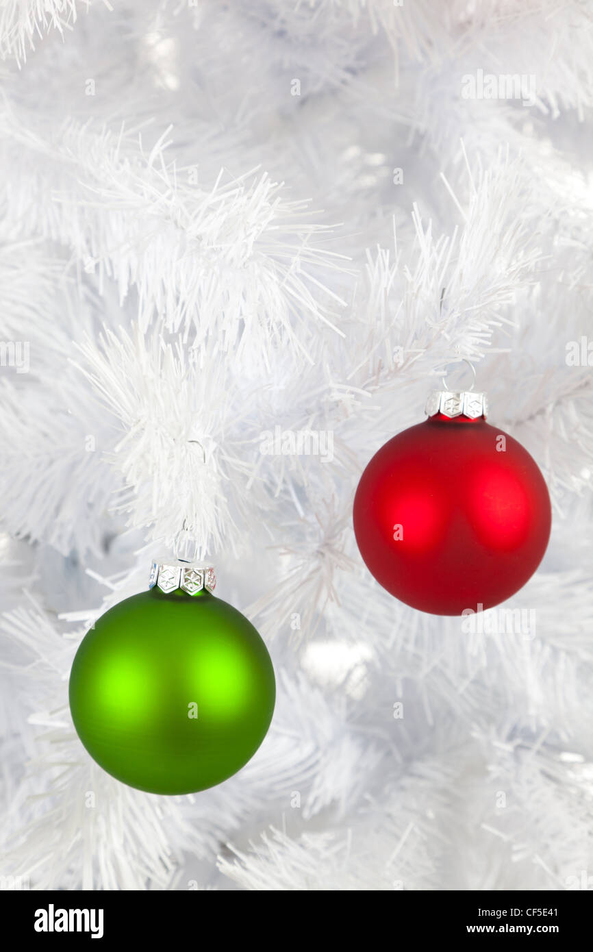 Colorful Christmas baubles, balls or ornaments on a white Christmas tree Stock Photo