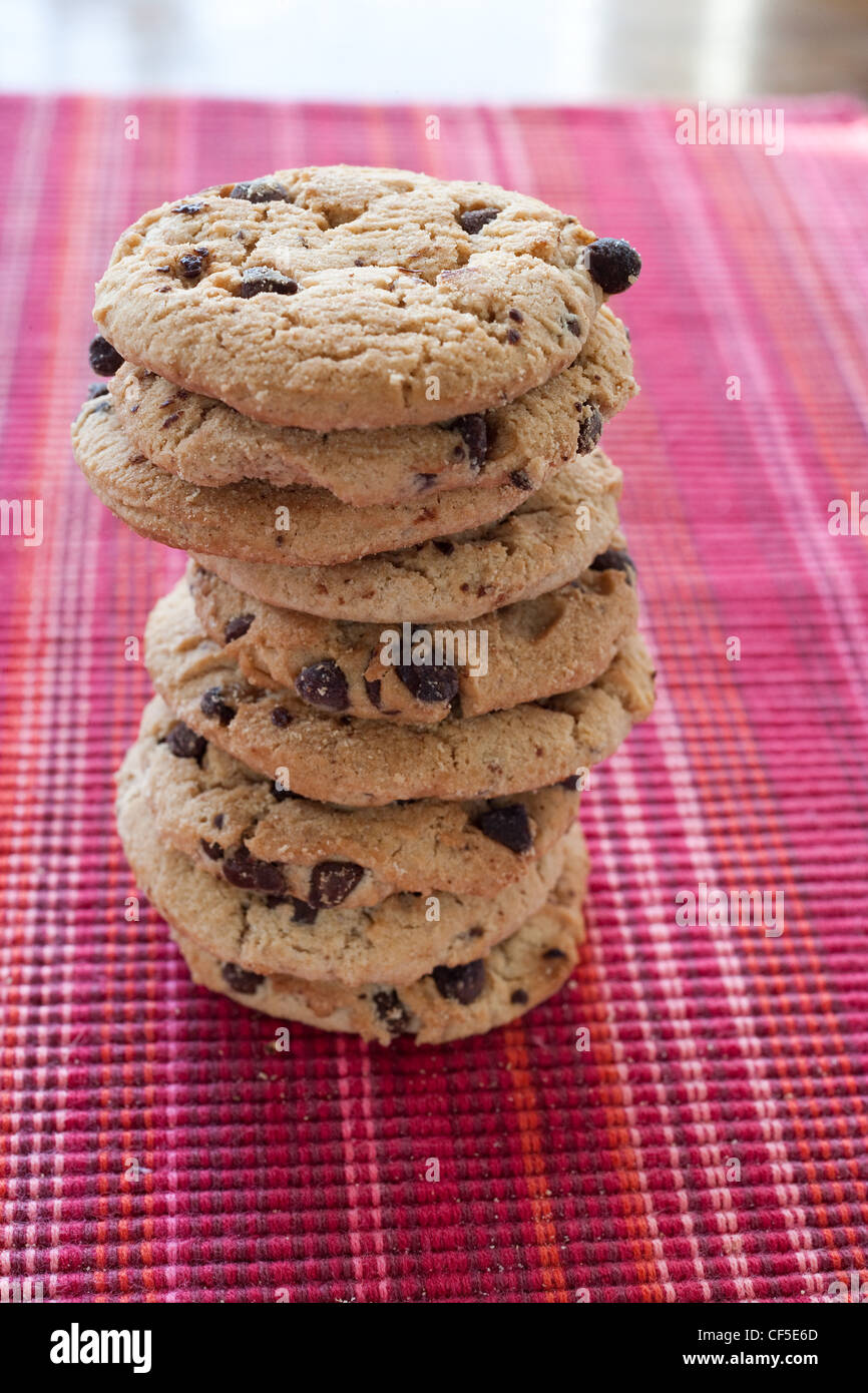 A stack of chocolate chip cookies on table Stock Photo