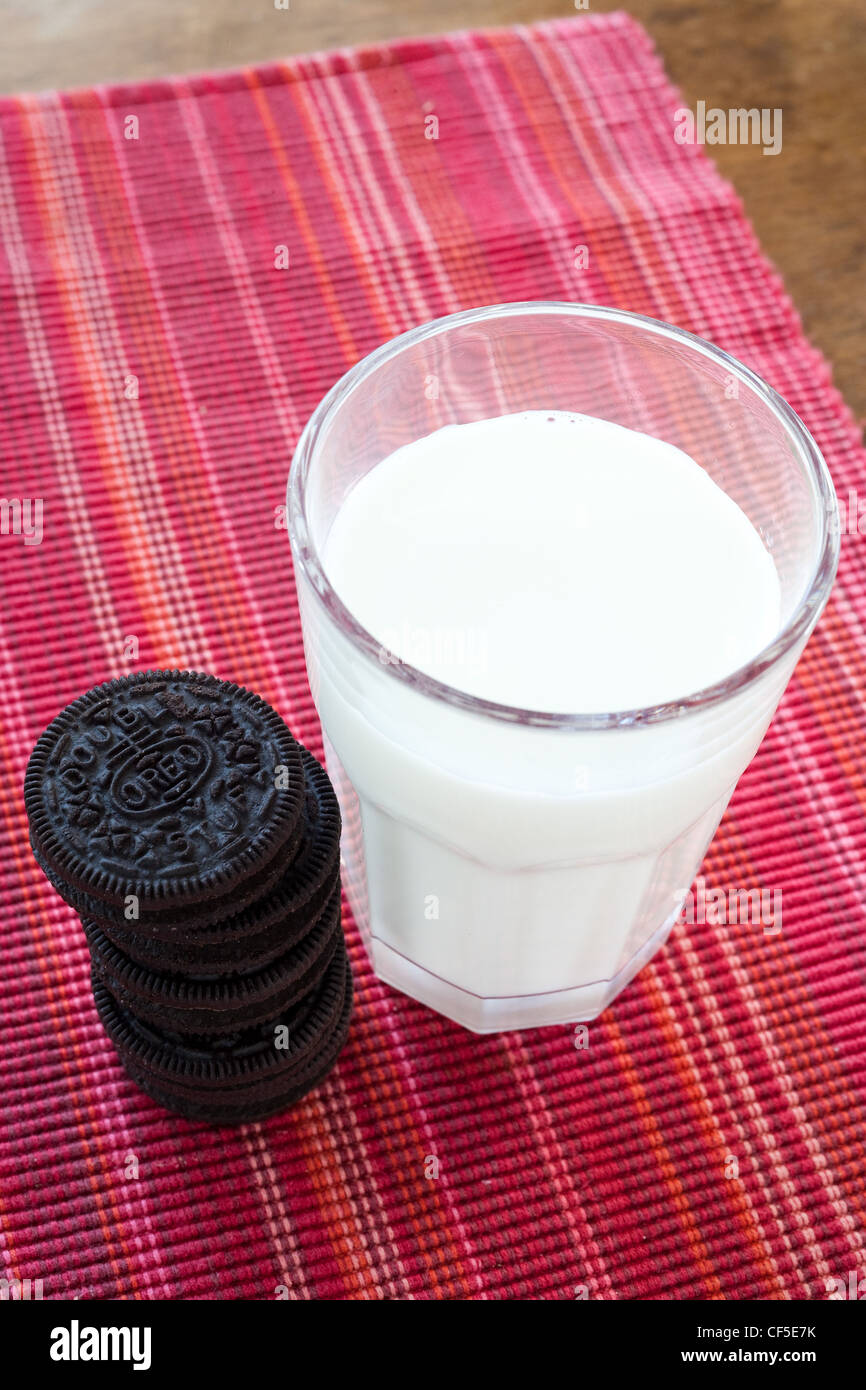 Oreo Cookies next to a glass of milk Stock Photo
