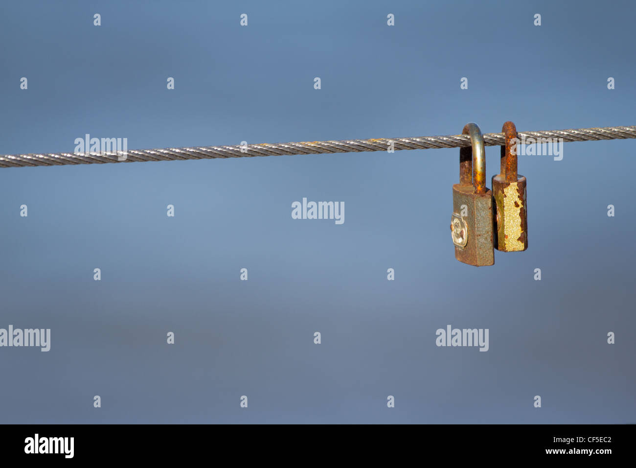 Rusty padlocks hanging on the cable in Rewal, Poland. Stock Photo