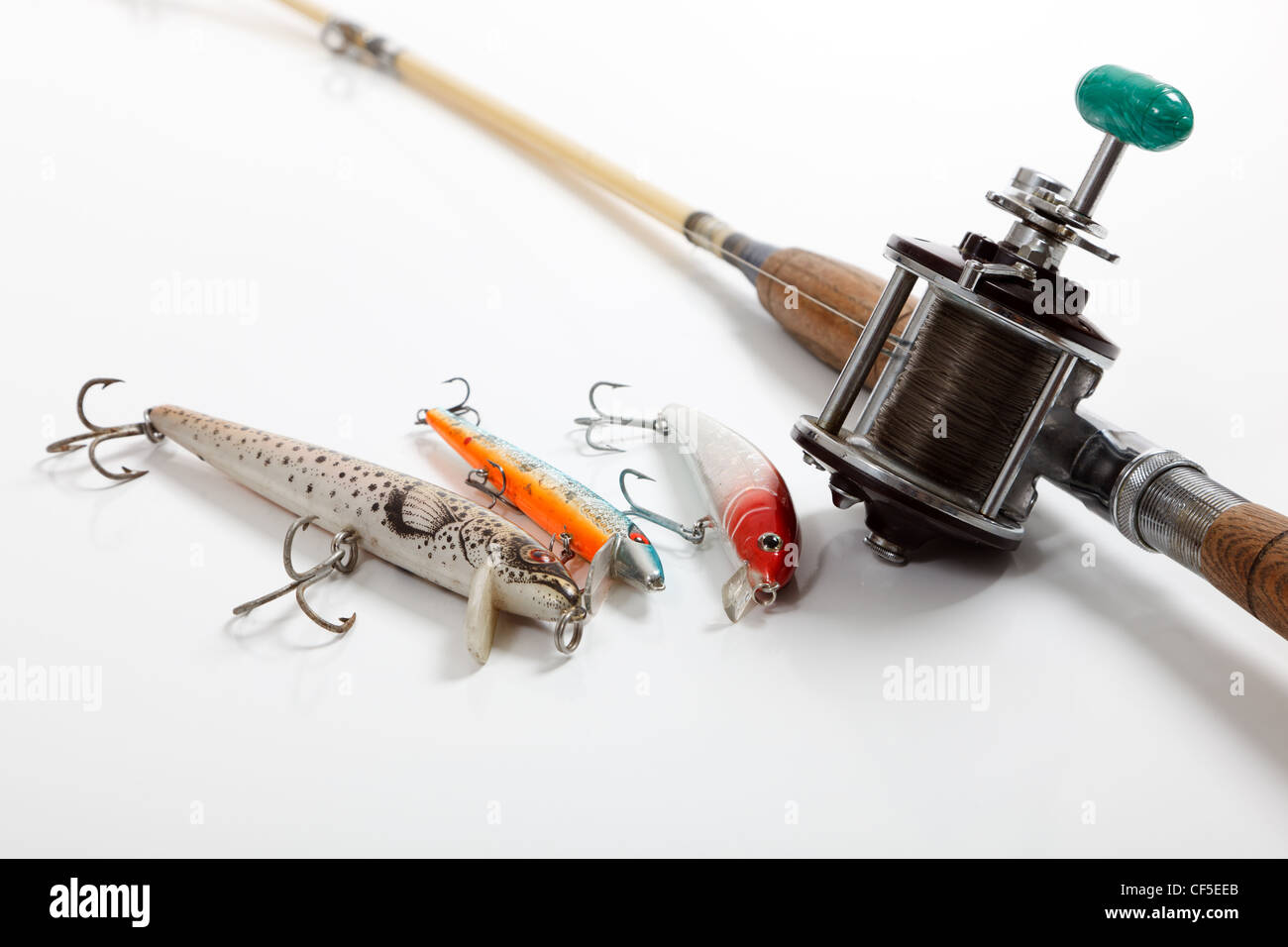 A set of fishing supplies on a white background including lures and a rod and a fishing rod and reel Stock Photo