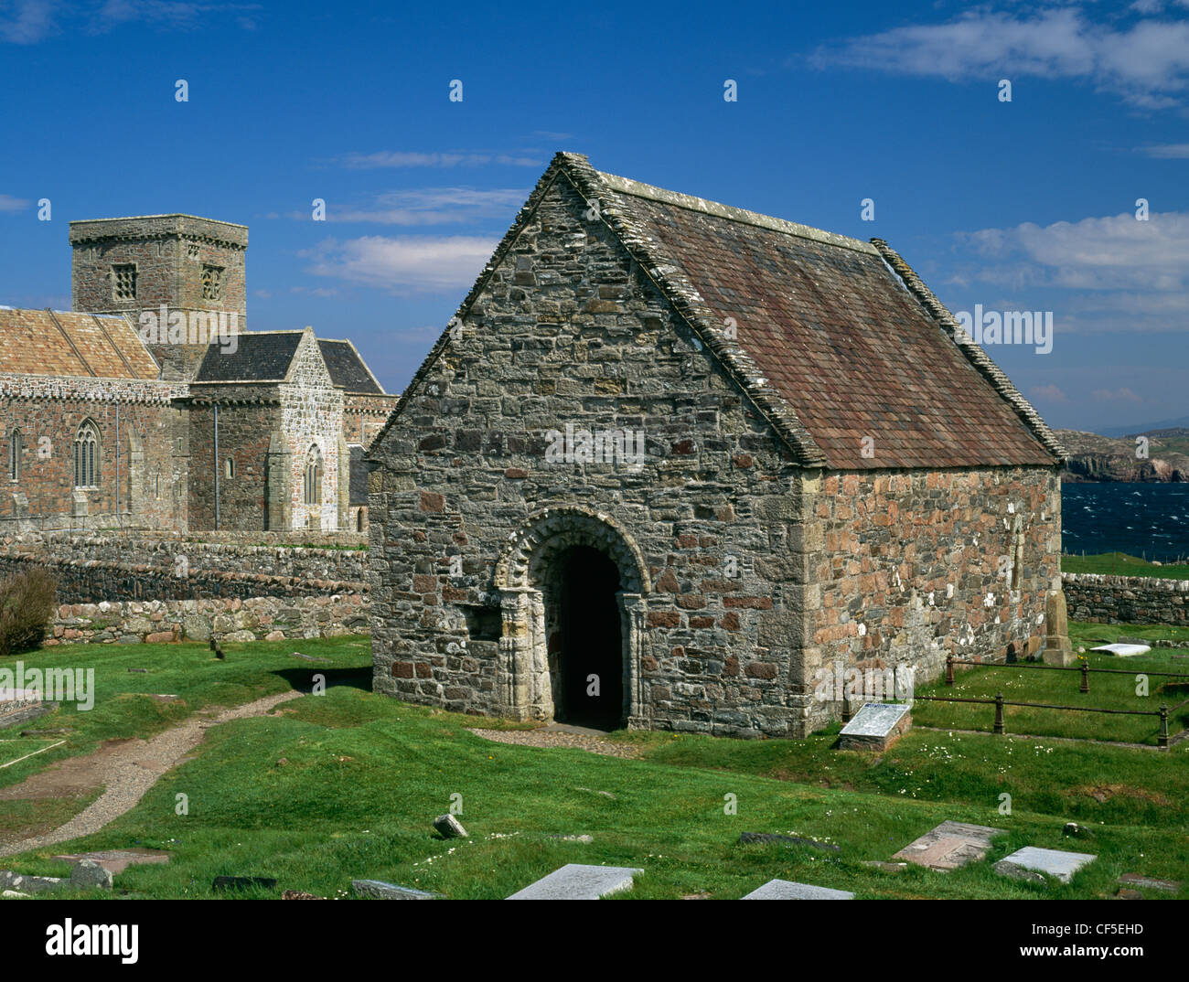 Medieval chapel and burial-ground dedicated to Columba's cousin St Oran. To the rear is part of Iona Abbey comprising St Mary's Stock Photo
