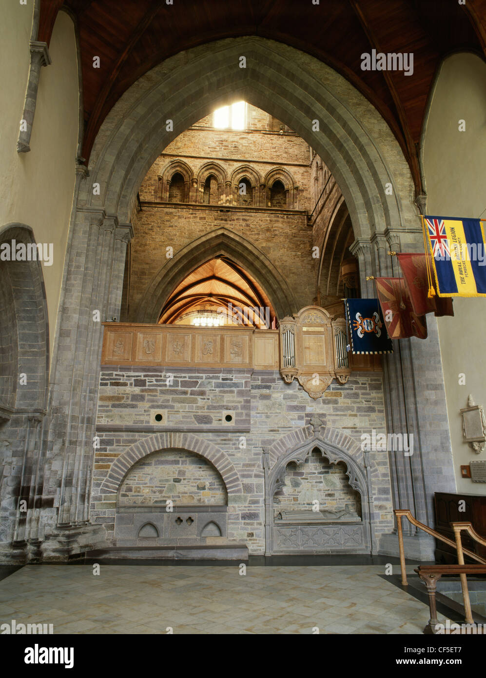 St Caradoc's shrine (left) in the south wall of the North Transept of St David's Cathedral. To the rear is the tower with choir Stock Photo