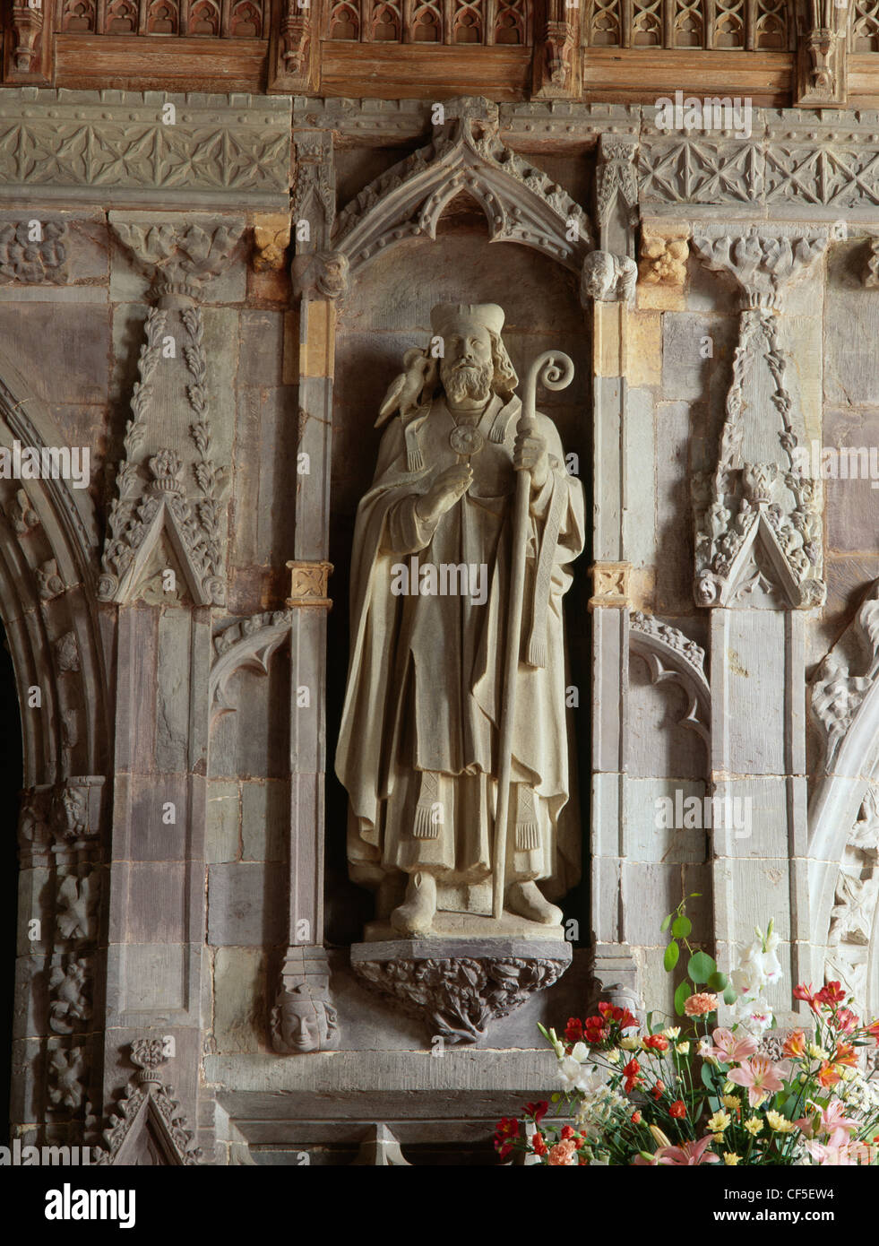 A modern statue of St David (Dewi Sant), patron saint of Wales, placed in the 14th-century rood screen between the nave and choi Stock Photo