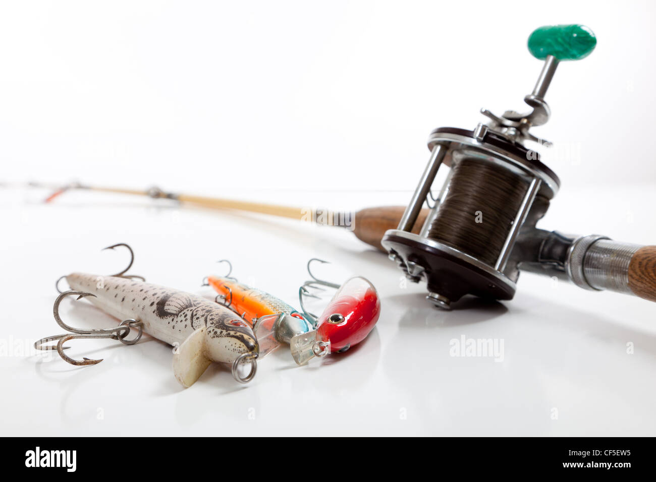 Fishing pole with fishing lures on a white background Stock Photo