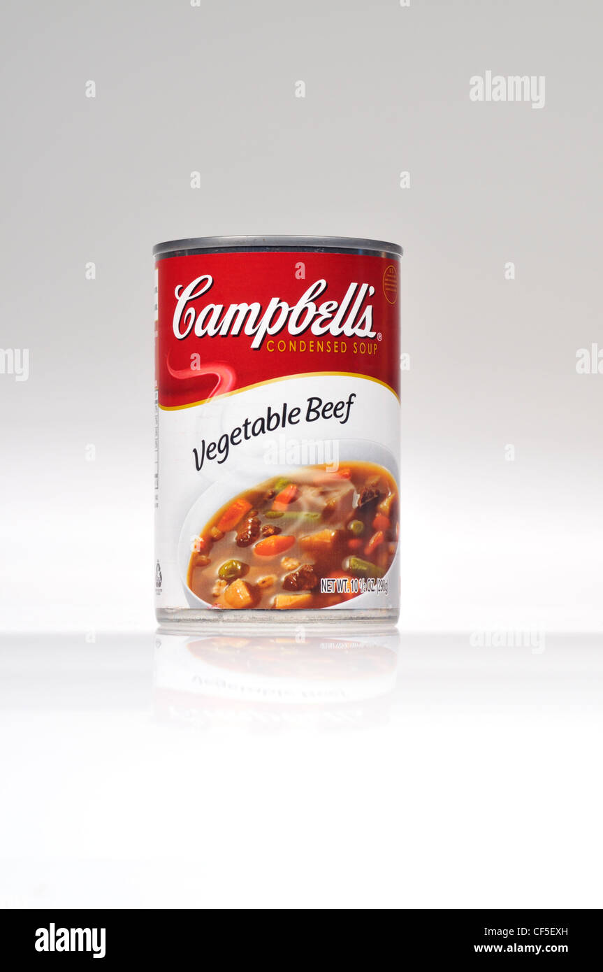 Unopened tin of Campbell's soup vegetable beef on white background cut