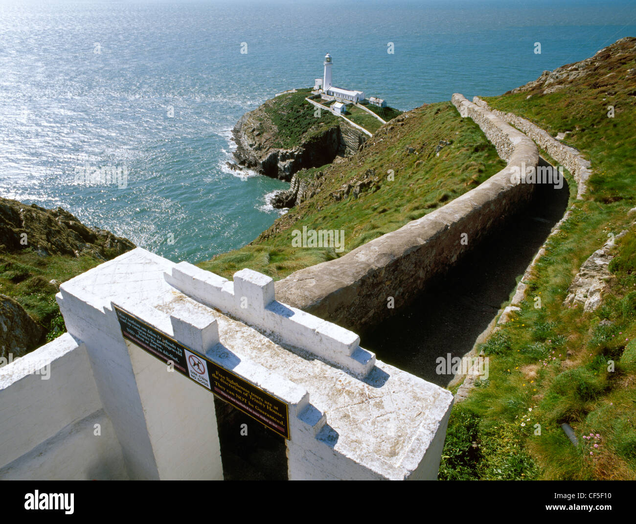 Gateway and access path leading to The South Stack lighthouse on a small, rocky island in the Irish Sea off the NW corner of Hol Stock Photo