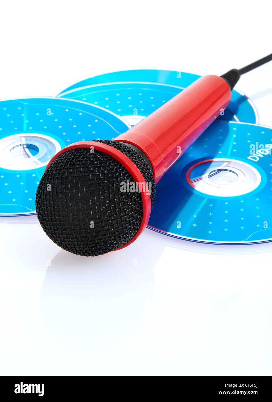 Red Microphone and blue CDs to record songs Stock Photo Alamy