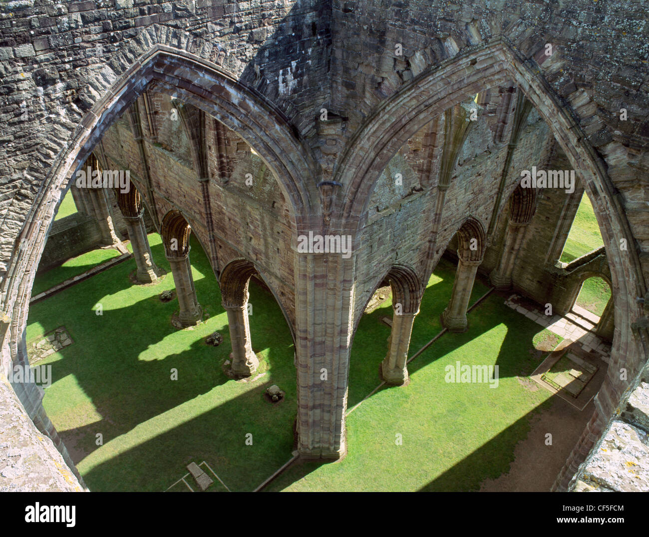 Looking down into the crossing of the ruined Tintern Abbey church with the chancel to the left and the south transept to the rig Stock Photo