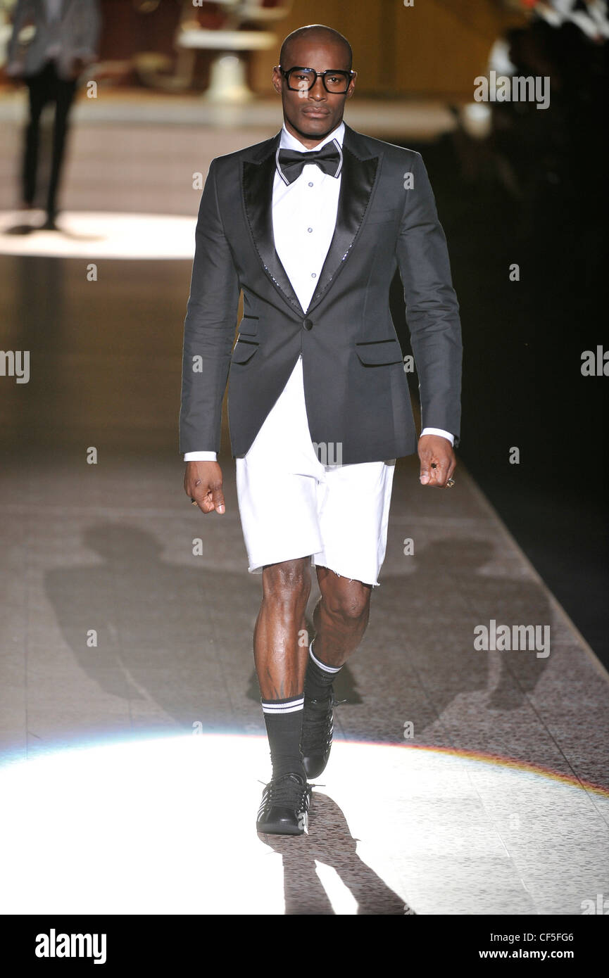 Dsquared Milan Ready to Wear Spring Summer Model wearing a white shirt,  black bow tie, black dinner jacket, white shorts Stock Photo - Alamy