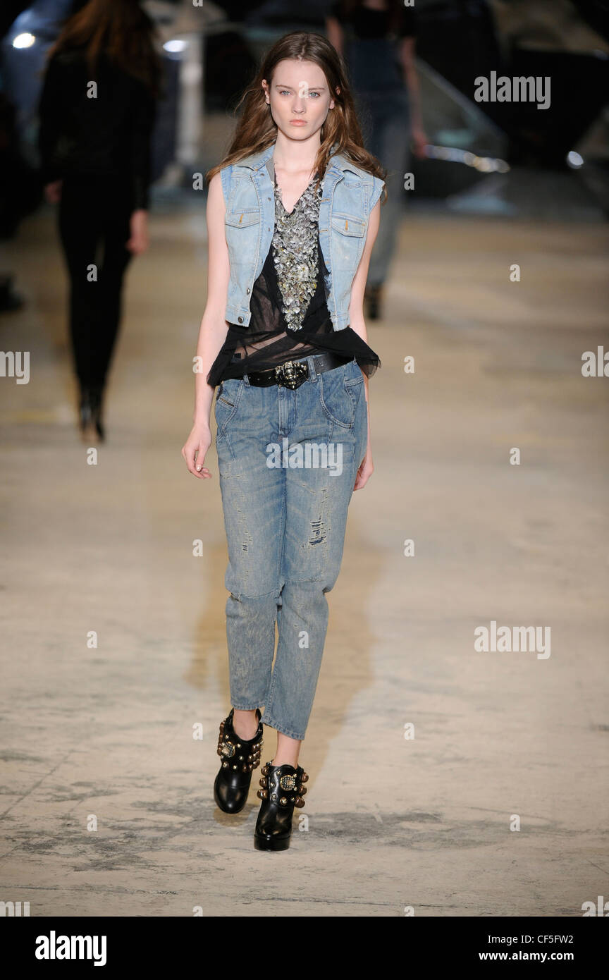 Diesel Black Gold New Ready to Wear Autumn Winter Denim frilled top, weathered cropped jeans black belt and Stock Photo - Alamy