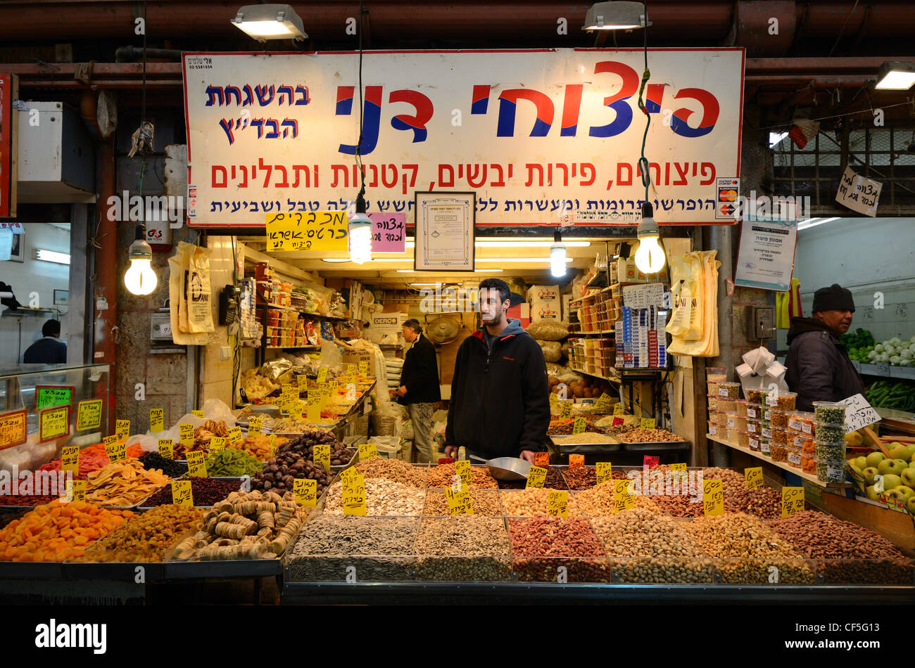 An Israeli vendor sells dried fruits and nuts in a Jerusalem suq. Stock Photo