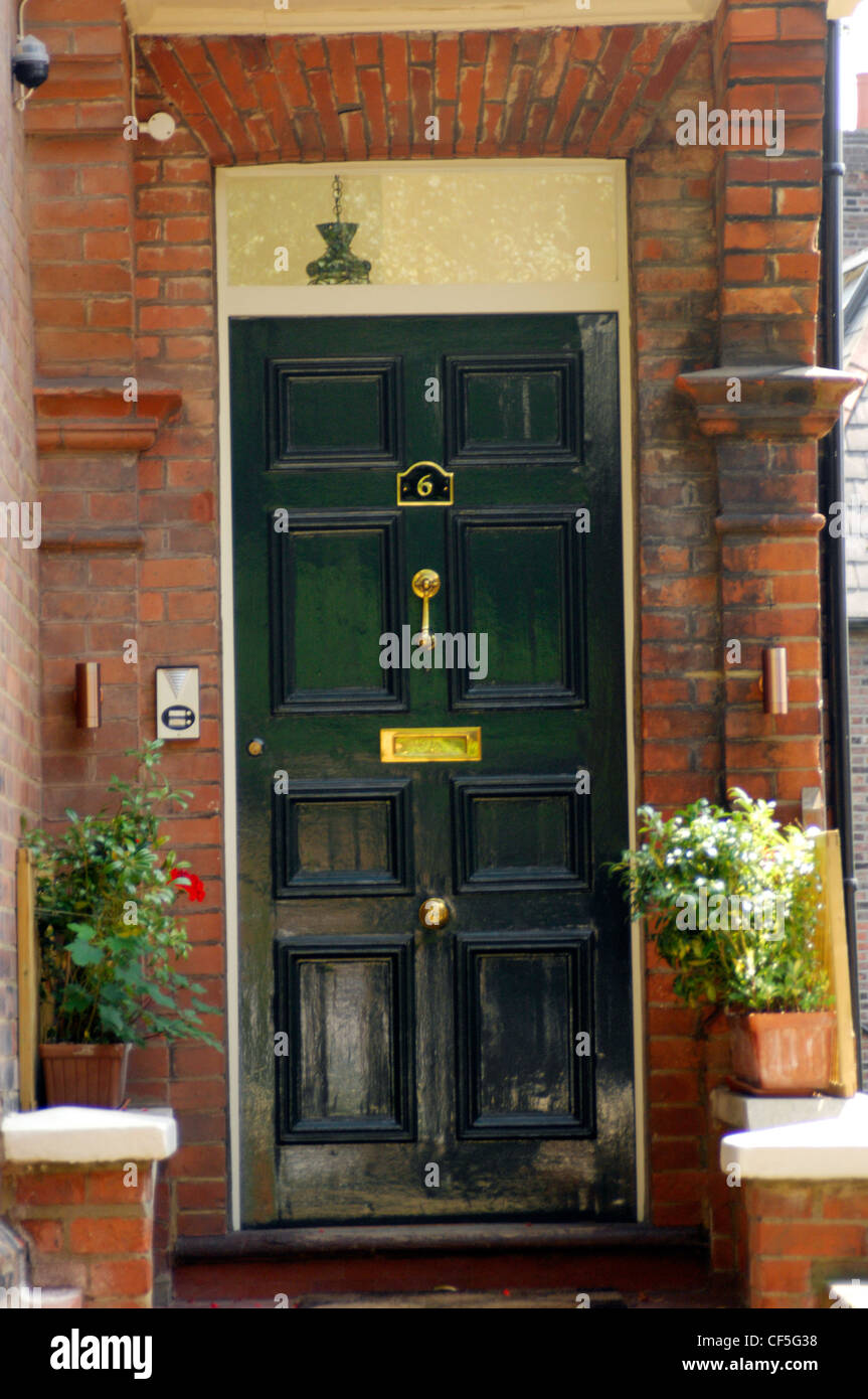 Glossy Black Front Doto A Red Brick House With Brass Letter Box