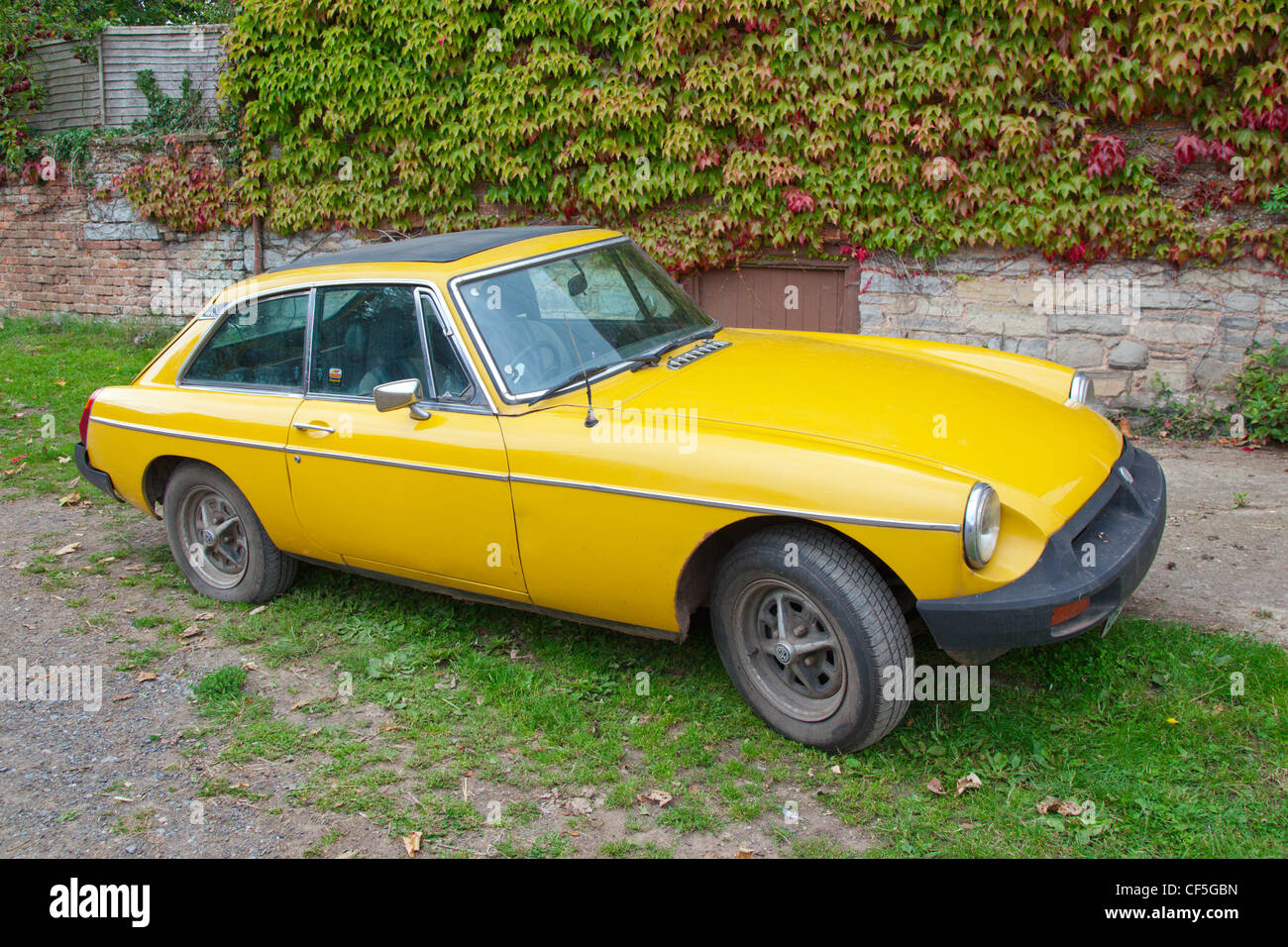 A yellow MGB, an iconic British sports car first built in 1962