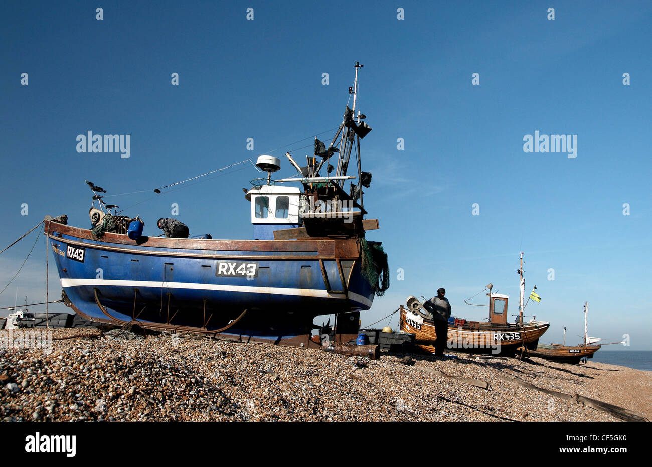 Boats on Dungeness beach. Dungeness consists of a complex of shingle and marsh situated along a 38-km stretch of coastline in Ke Stock Photo