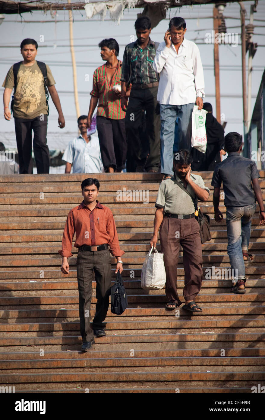 Indian people commuting to work from Dharavi slums in Mumbai, India Stock Photo