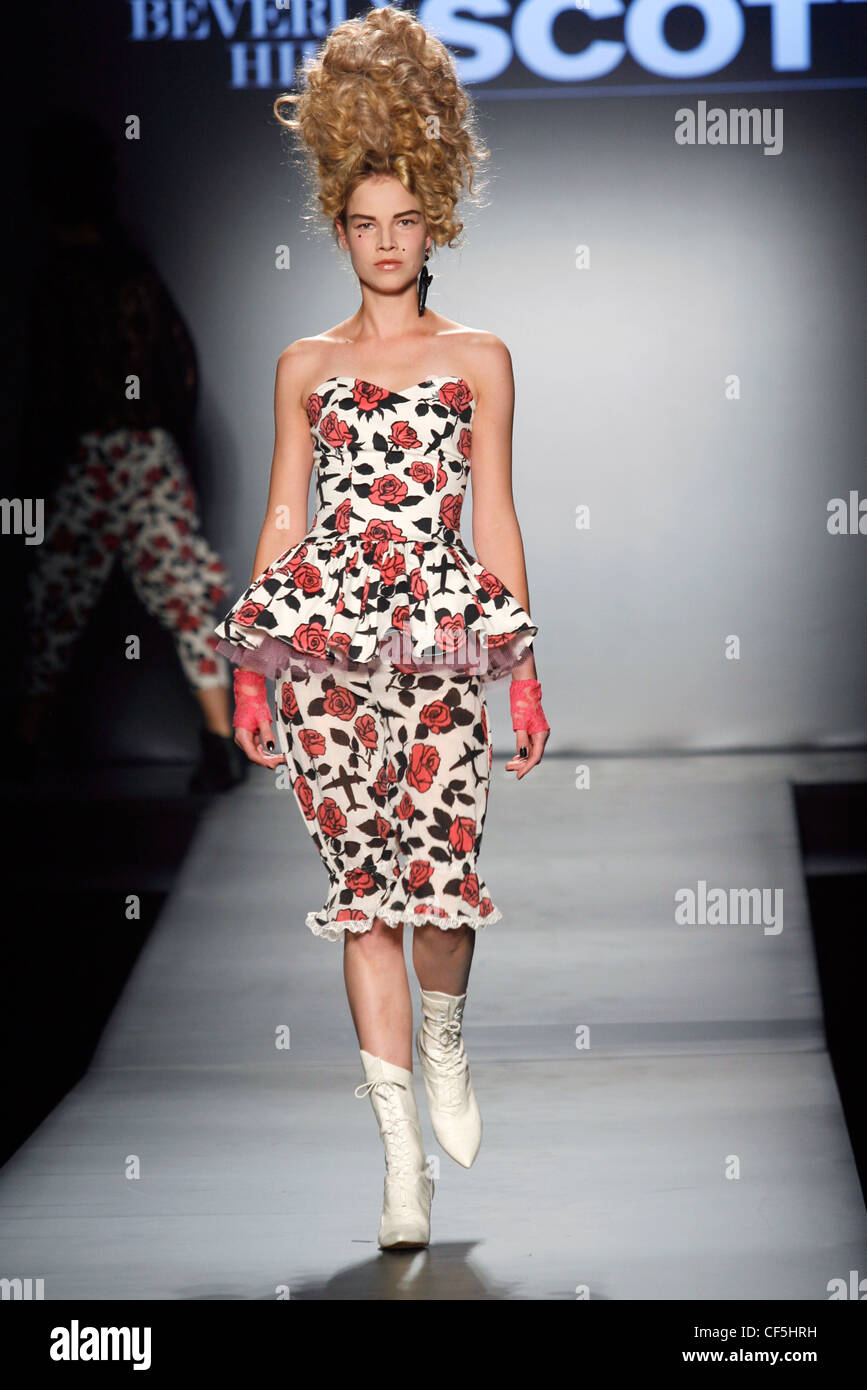 Jeremy Scott Paris Ready to Wear Spring Summer Model tall blonde curly wig wearing empire line top ruffled around waistline Stock Photo Alamy