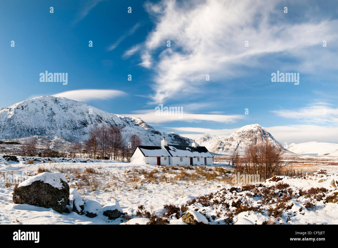 A snow covered landscape featuring Black Rock cottage in Glencoe. Stock Photo