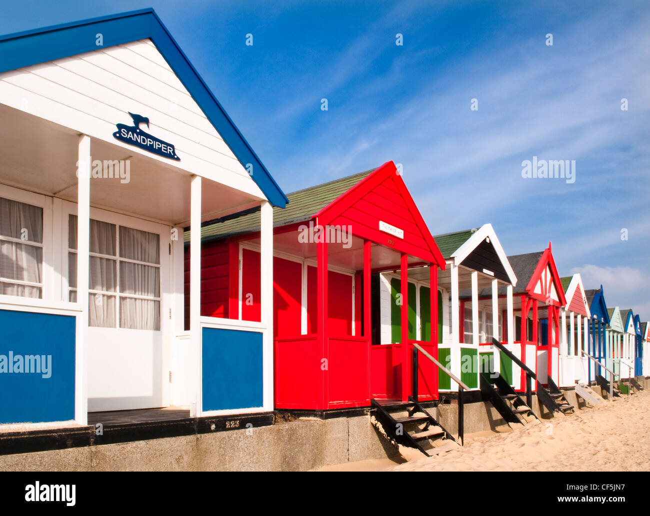 Colourful beach huts along the seafront in Southwold. Stock Photo