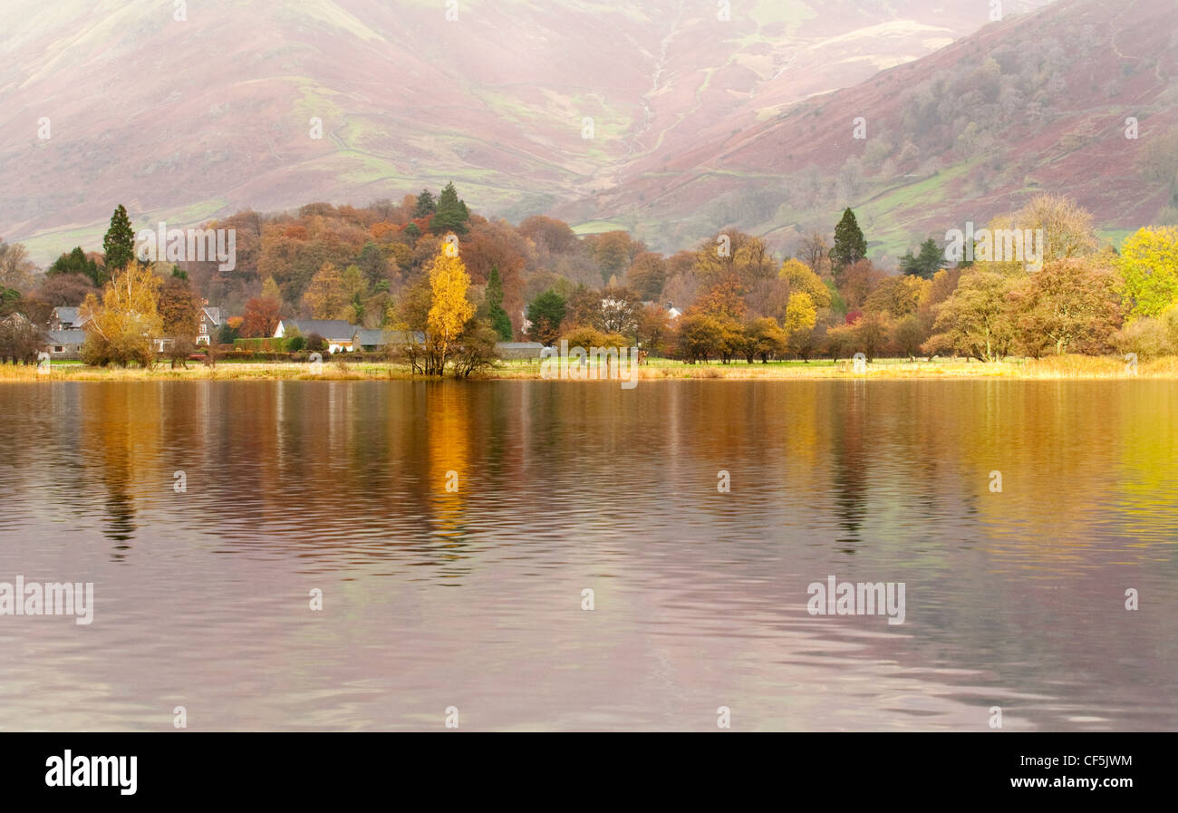 Autumnal colours reflected in Grasmere lake in the Lake District. Stock Photo