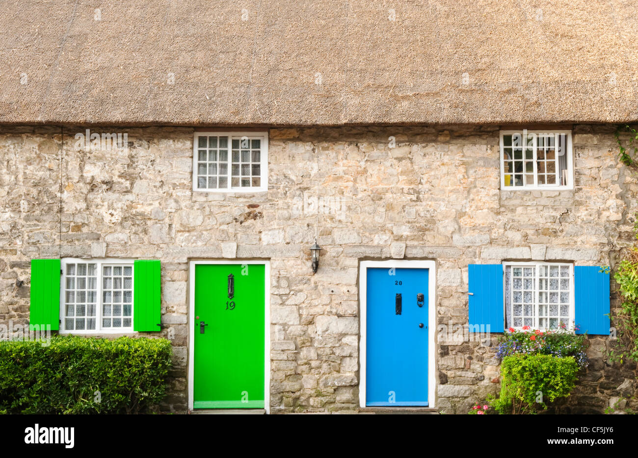 Front doors and window shutters on a traditional thatched cottage in West Lulworth. Stock Photo