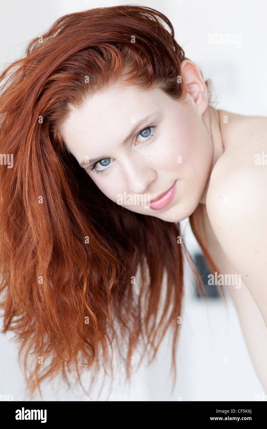 Female with ginger hair, wearing subtle make up, smiling, looking at ...